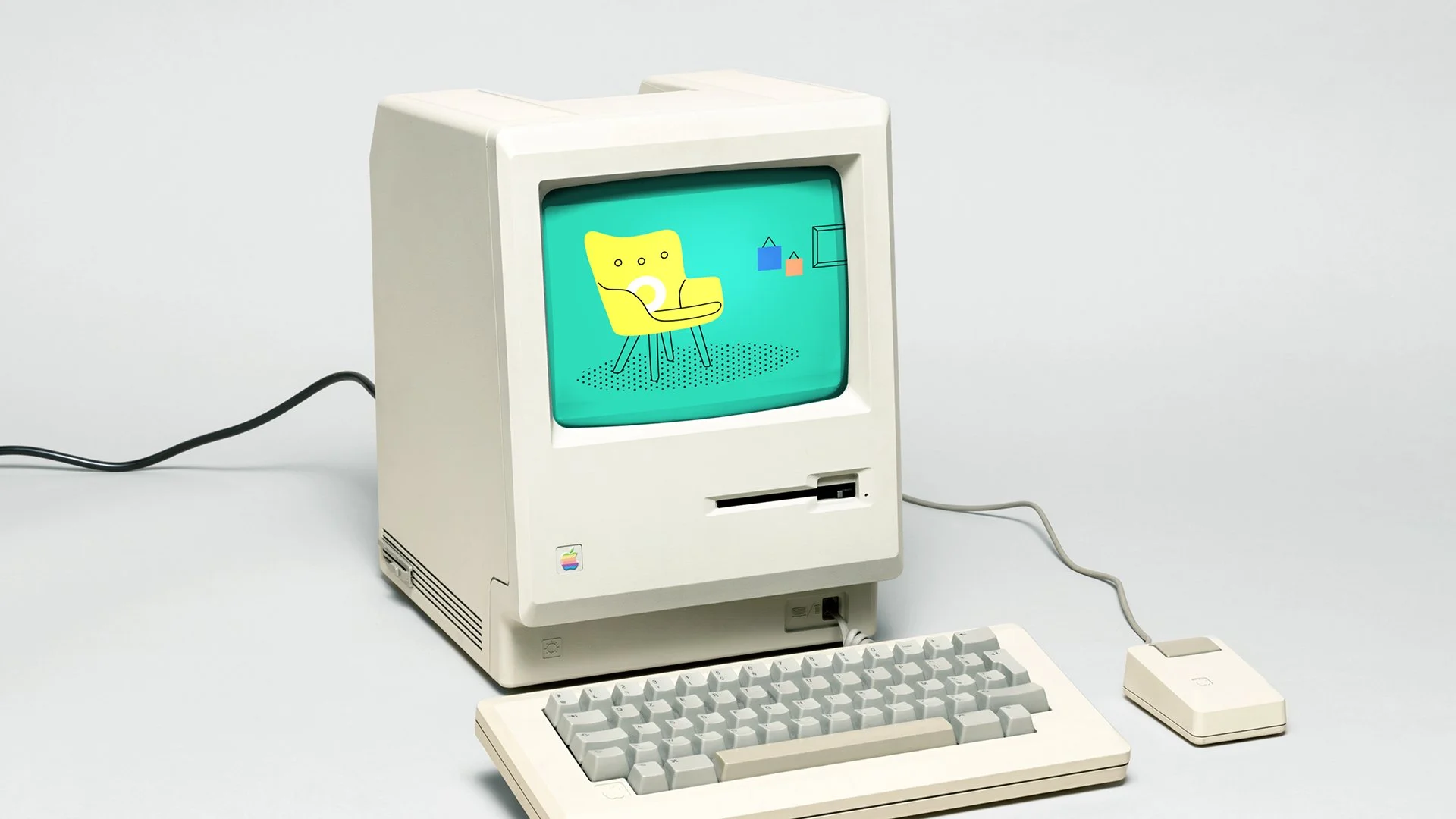 An old fashioned computer holds at Studio Hoopla-esque image with a comfy armchair to feel like 'home'