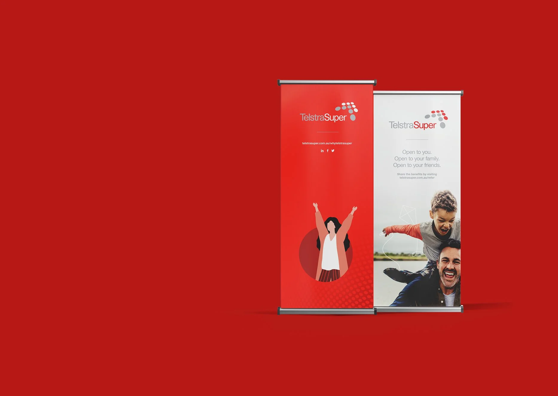 Red and white vertical banners with the Telstra Super logo, displaying images of a woman with raised arms and a man with a child on his shoulders, promoting family and community connection.