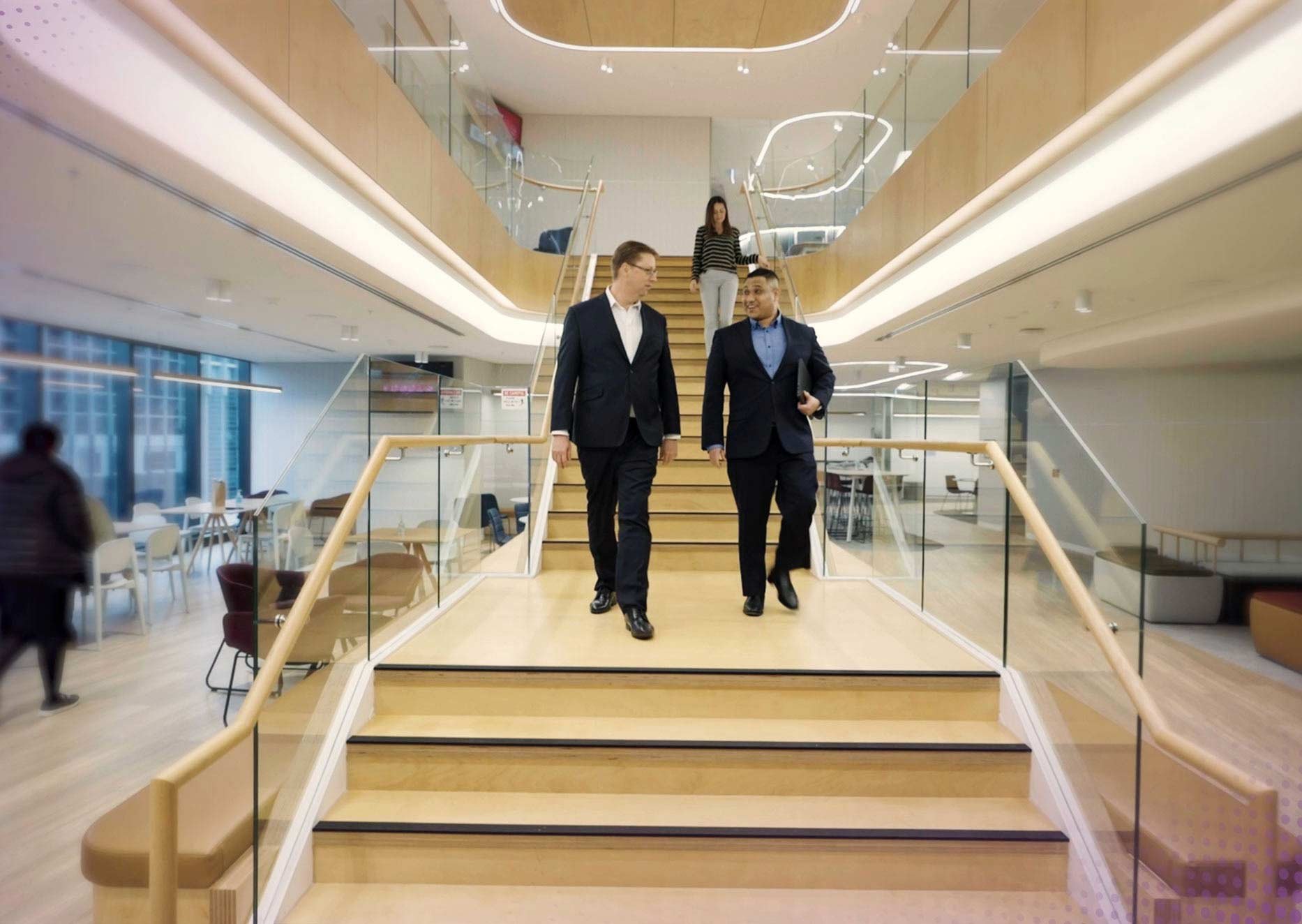 TesltraSuper employees walking down an internal staircase