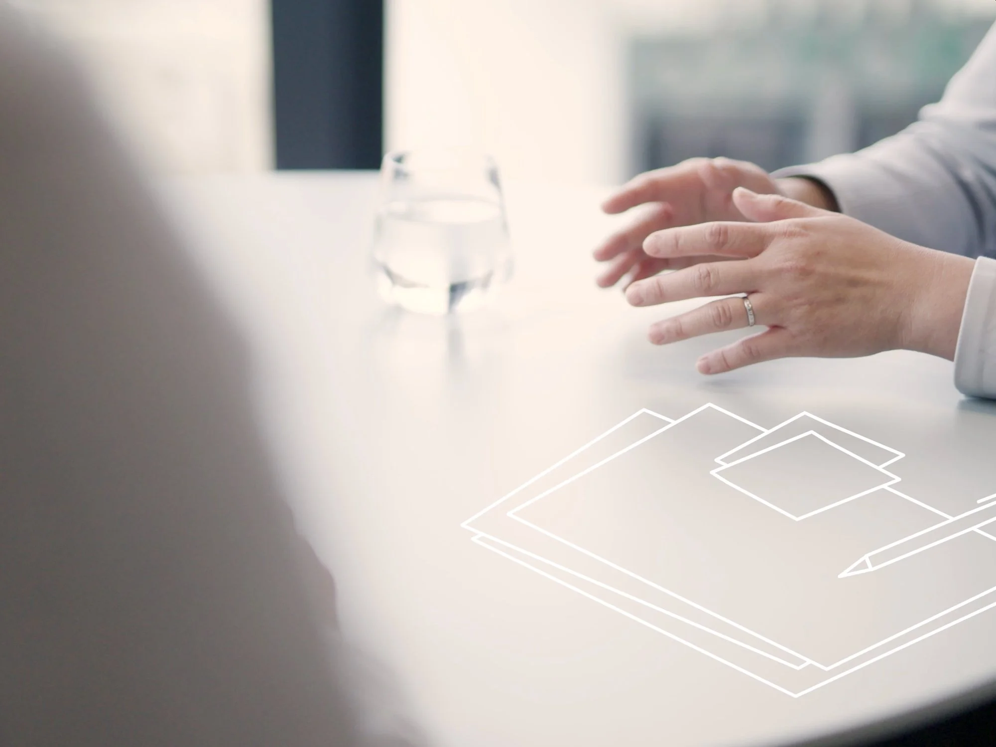 A persons hands in a meeting