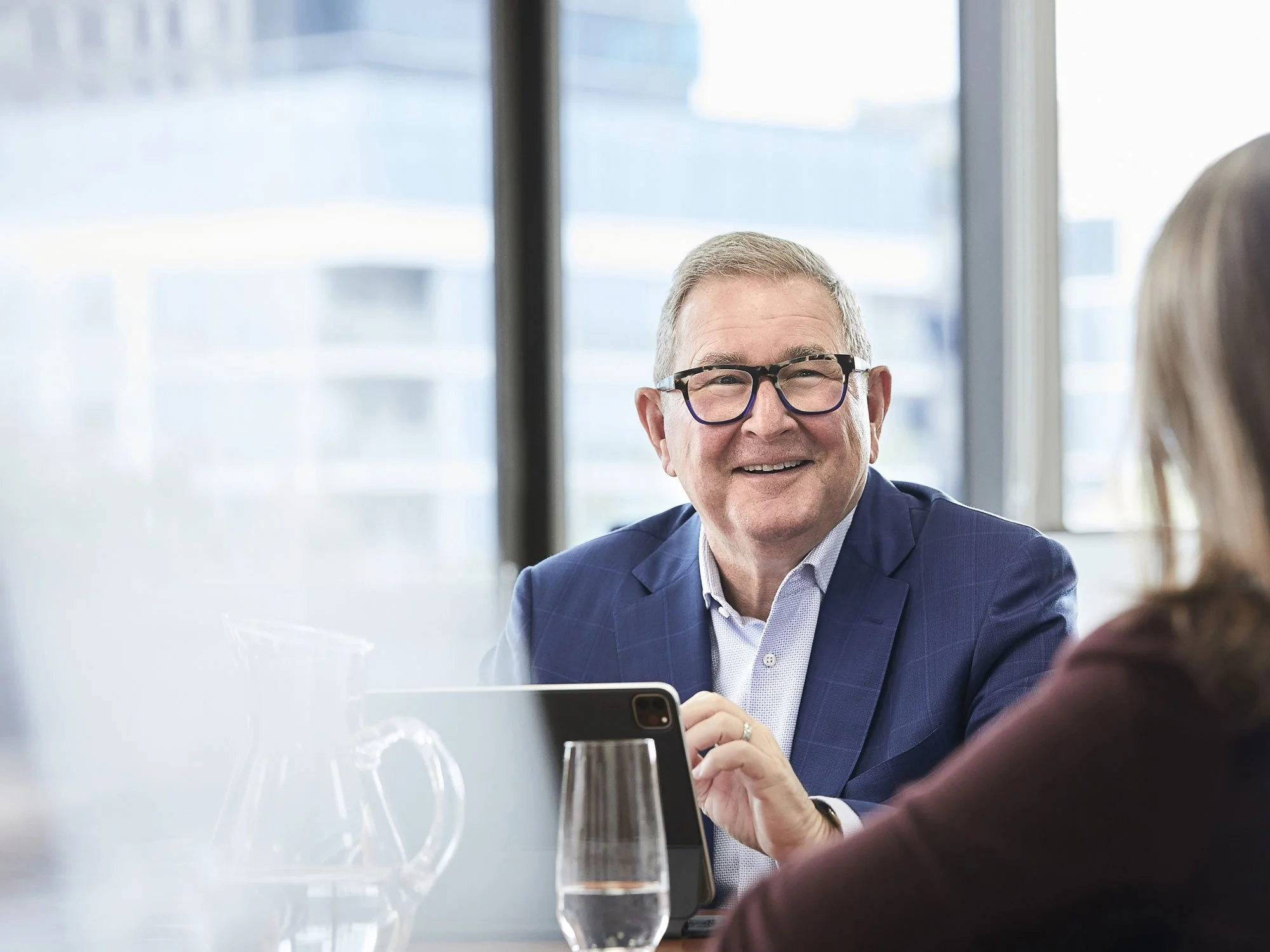 Photo of an older male in a suit jacket in an office building