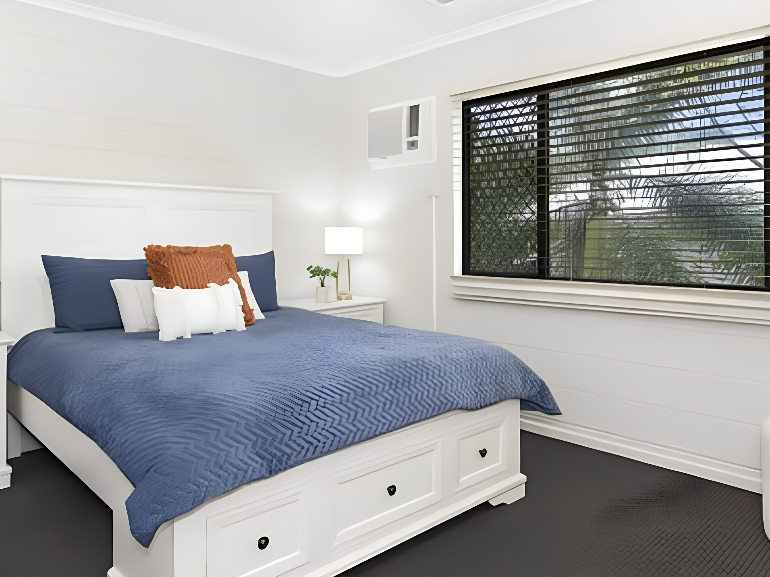Finished residential bedroom repaint with white walls and trim