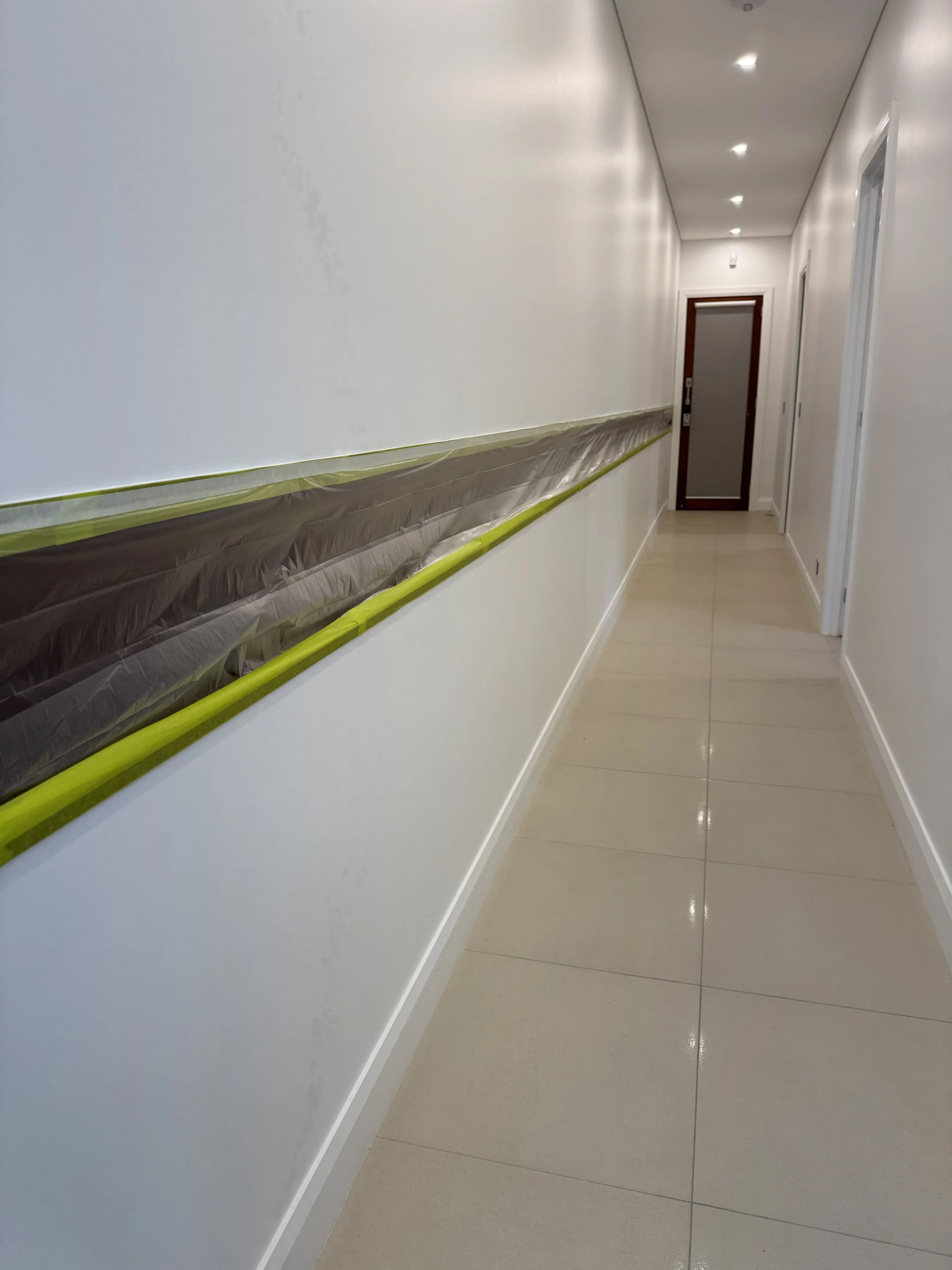 Freshly painted residential hallway with white walls and trim