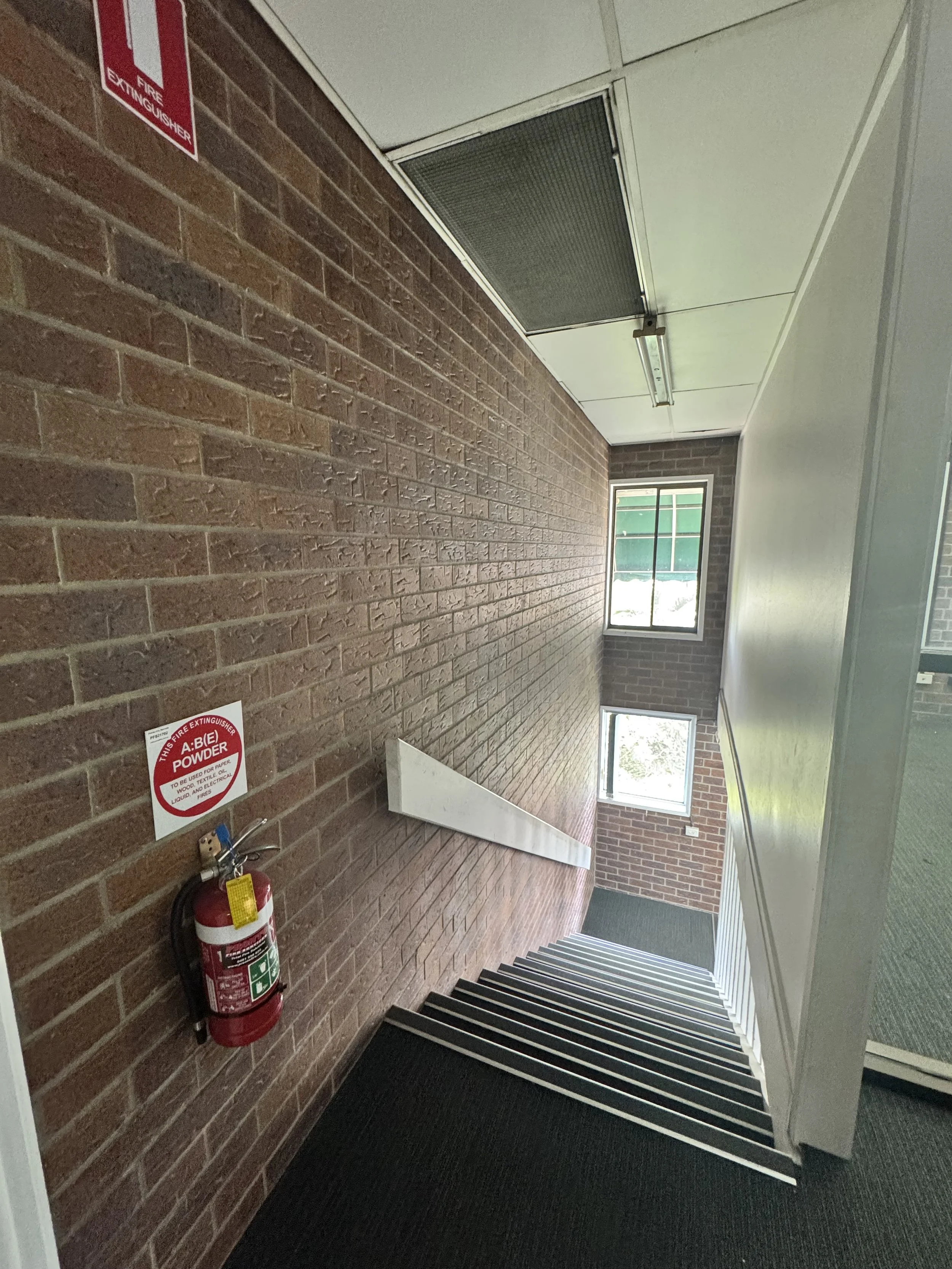 Painted commercial stairwell with black and white stairs
