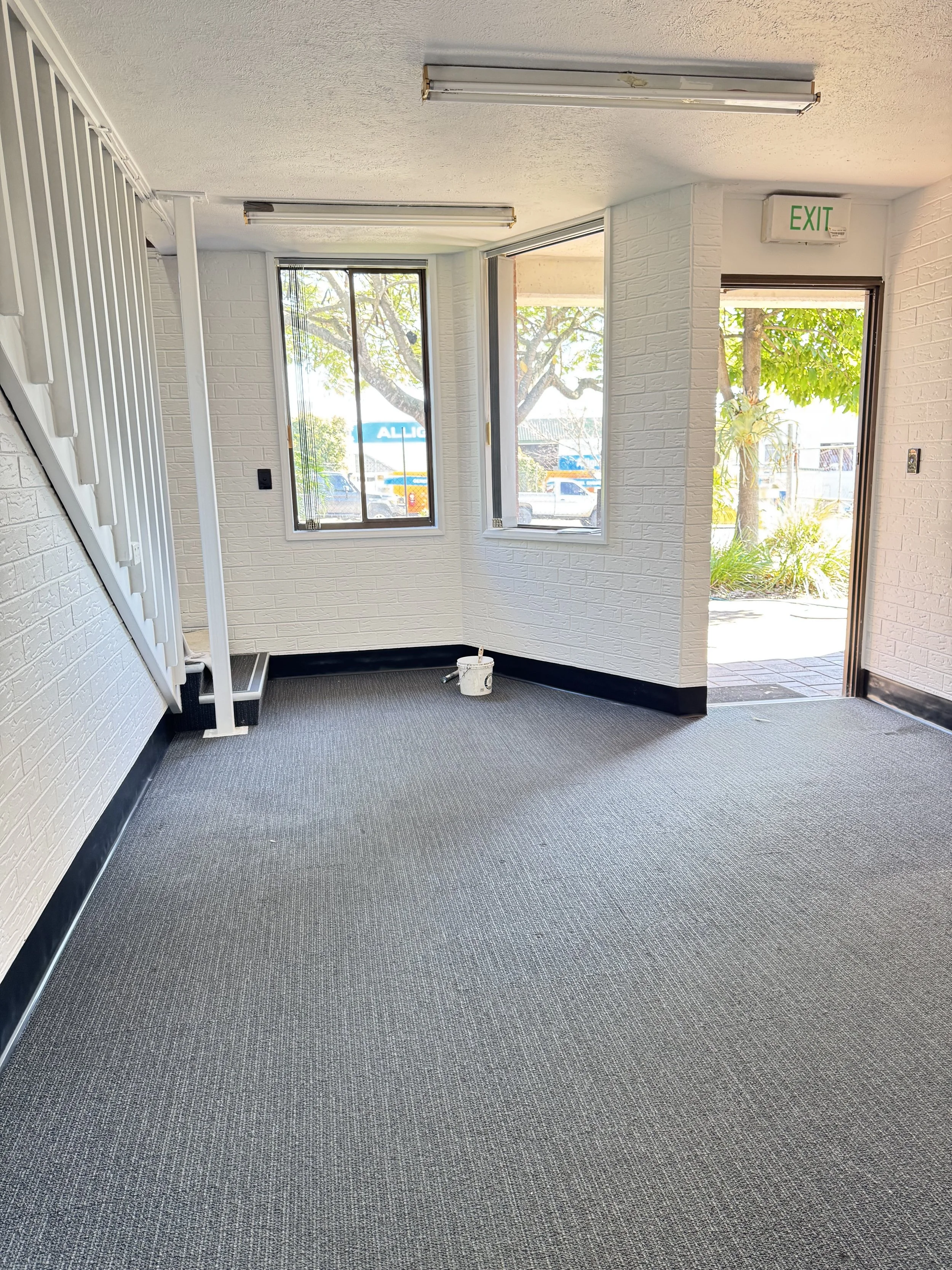 Freshly painted office with white walls and grey carpet