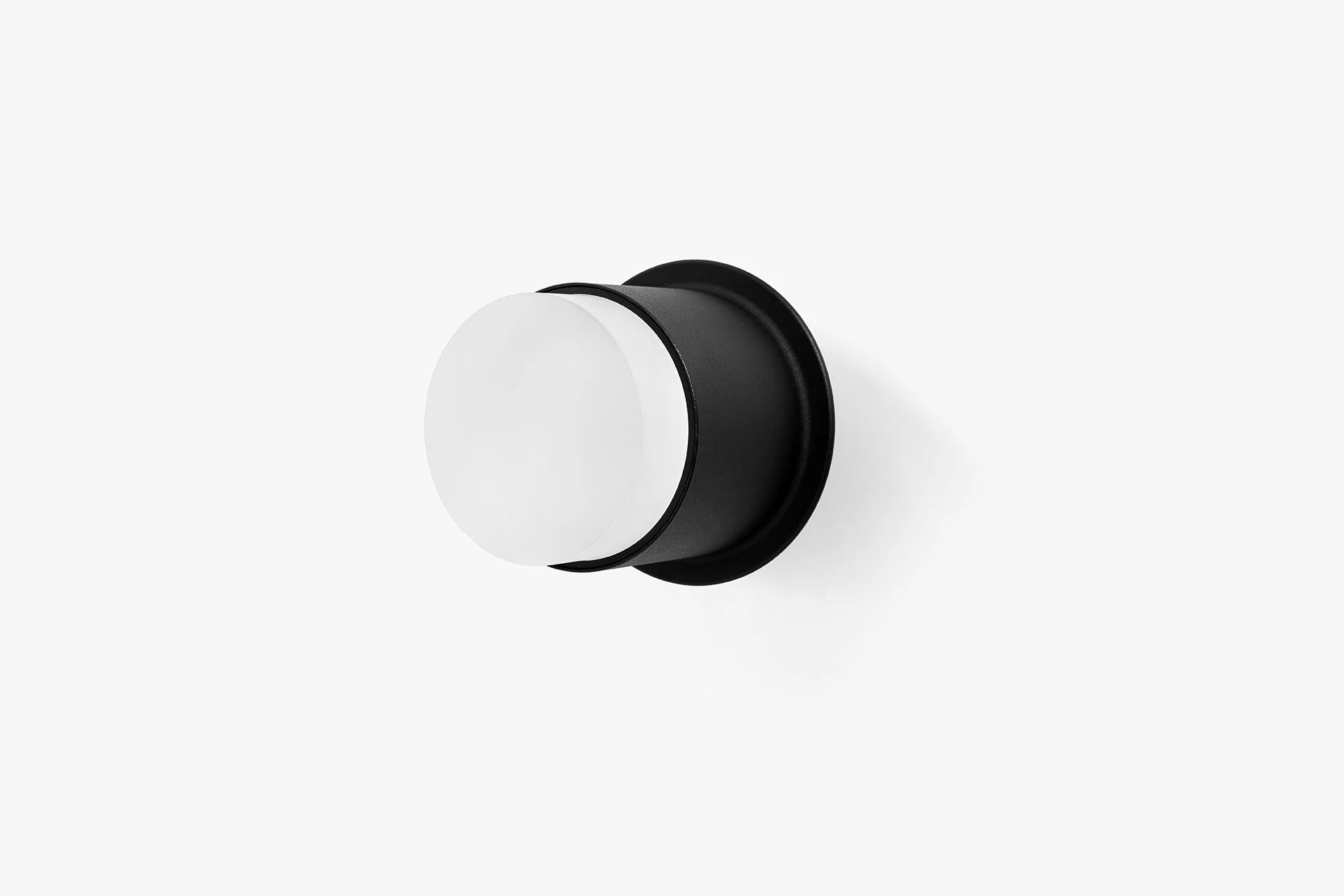 A black and white round surface-mounted luminaires for lighting interiors from ceilings and walls. by LIK Lighting, on a plain white background.