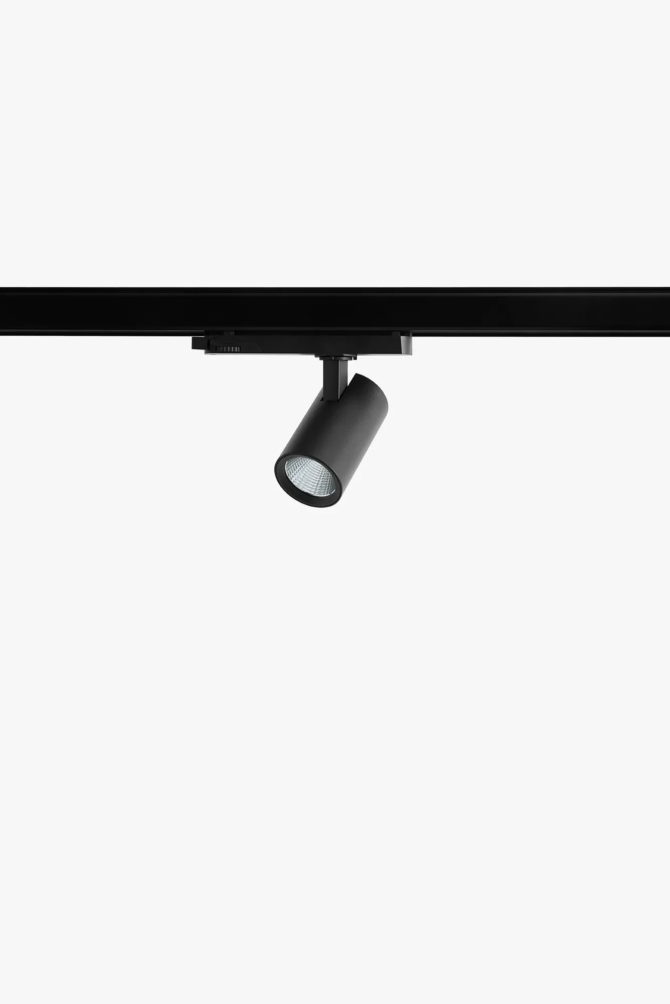 Close-up of a black track lighting and spotligt fixture by LIK Lighting, attached to a black rail, with a plain gray background.