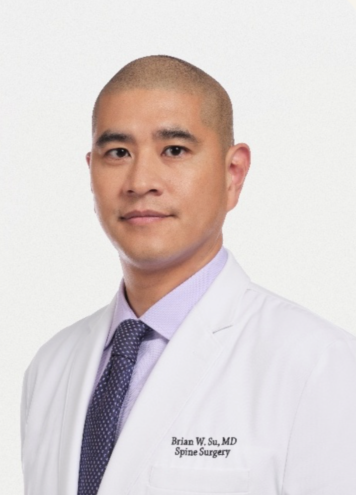 Professional portrait of Dr. Brian W. Su, MD, specializing in spine surgery, wearing a white coat, shirt, and tie, with a plain white background.