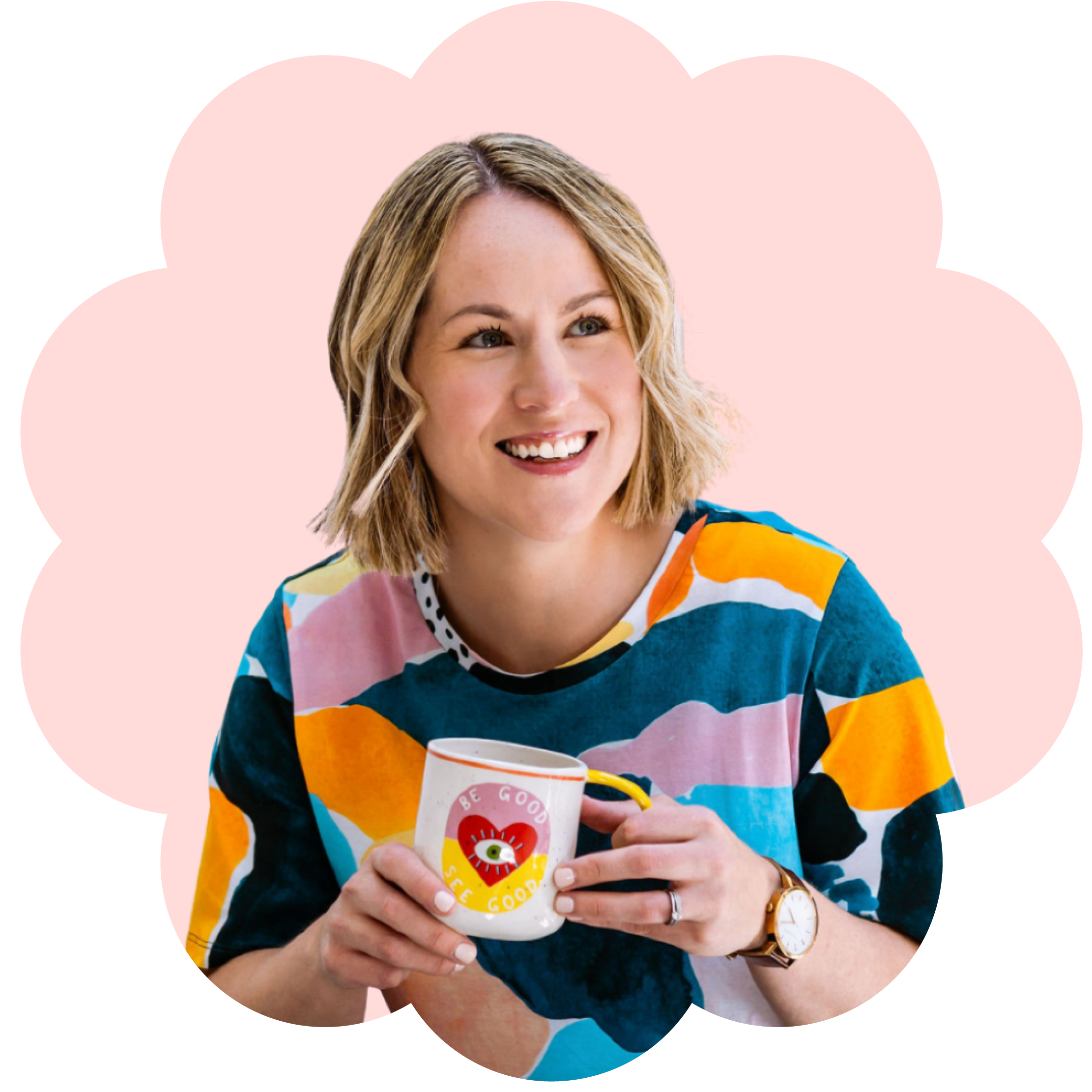 A smiling woman named Crystal Oliver with blonde hair wearing a colourful art printed shirt holding a white mug with a cartoon character and text that says 'Be Good, See Good.'