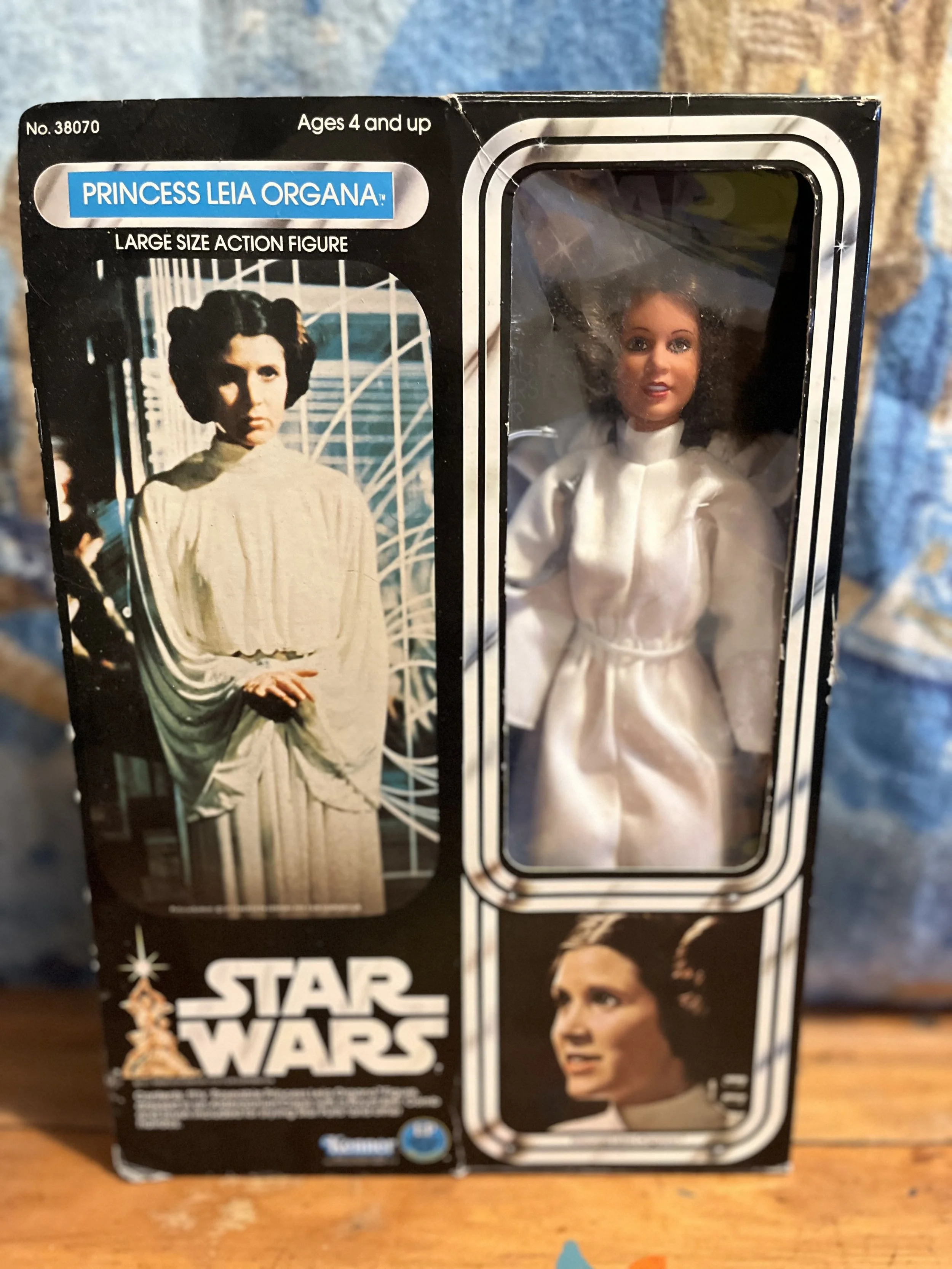 Star Wars Princess Leia Organa action figure in original packaging, with a photograph of Princess Leia on the box, and a window showing the action figure inside dressed in white.