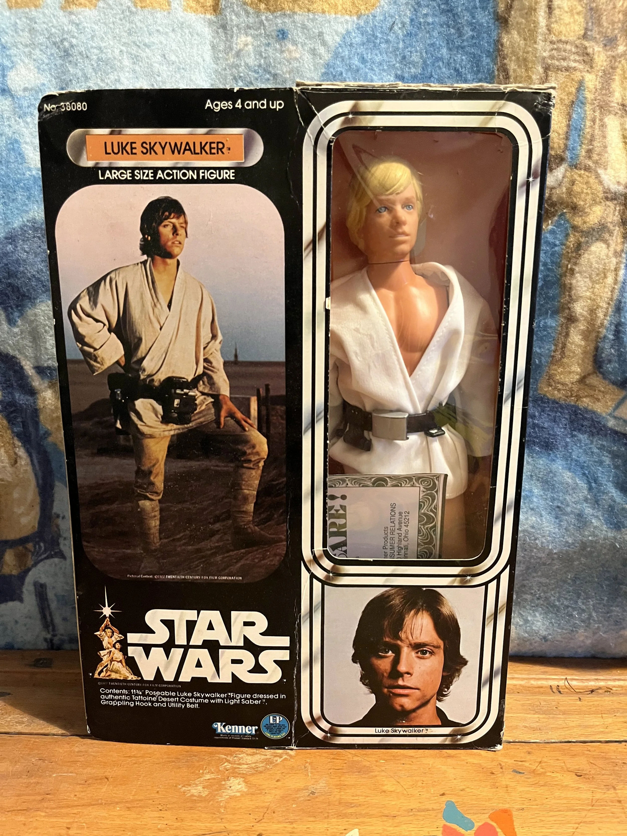 A vintage Kenner 12 inch Star Wars Luke Skywalker action figure boxed. The box features the character's image and label, with a black and white striped border around the figure's window.