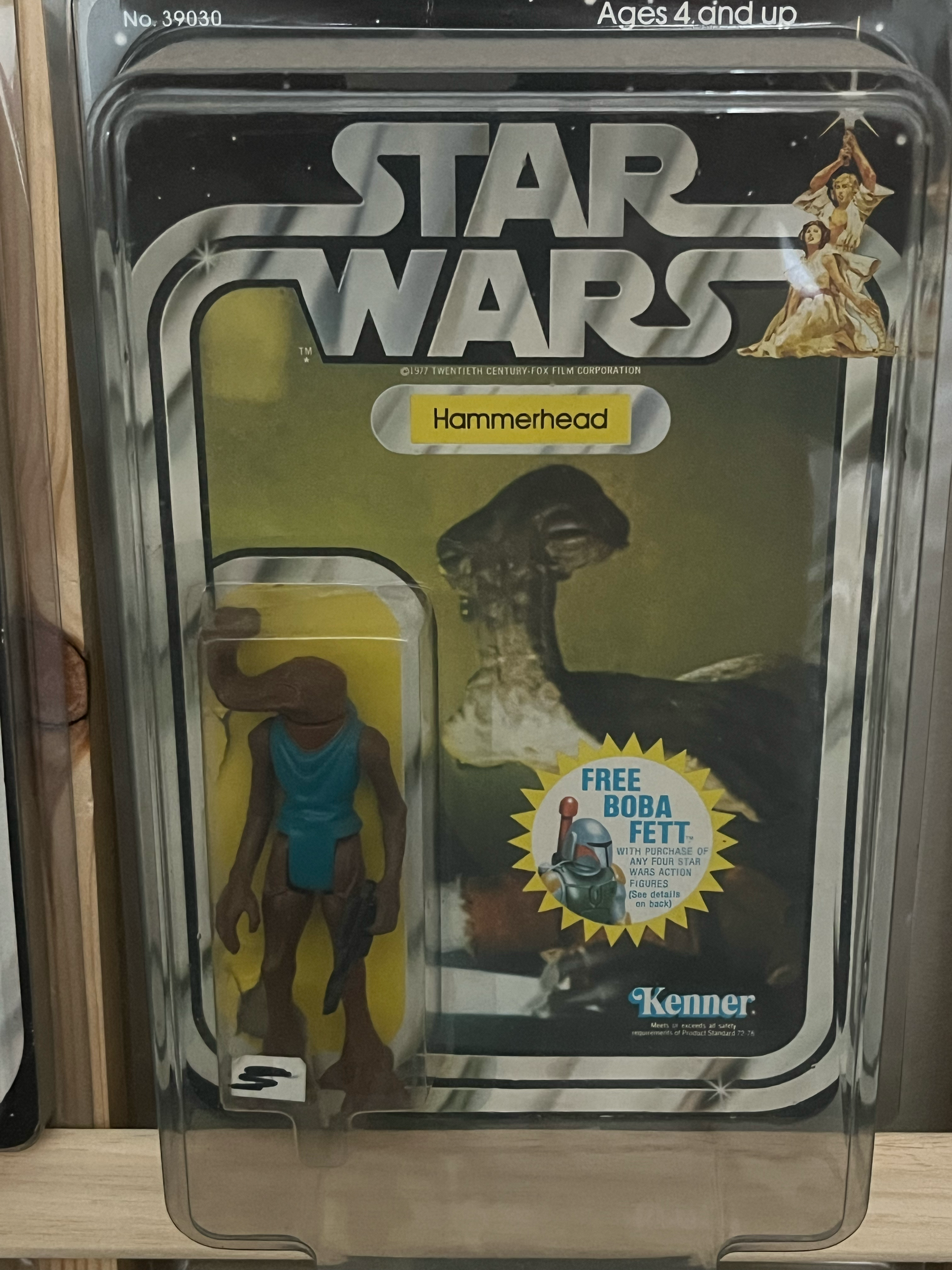 A vintage Star Wars action figure display case with characters from the original series, including a Jabba the Hutt figure and other figures in standing poses.