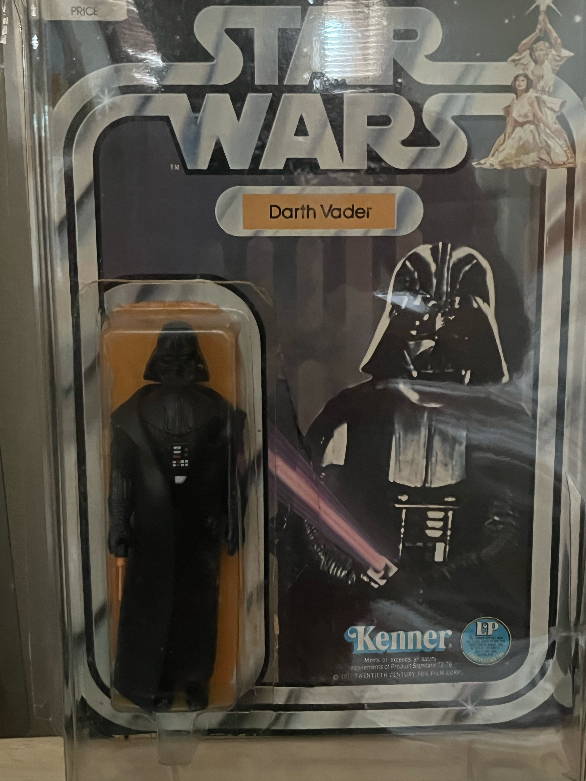 A boxed set of Darth Vader memorabilia including a Darth Vader action figure, a Darth Vader mask, and a Darth Vader lightsaber toy, all arranged in packaging with a Star Wars theme.