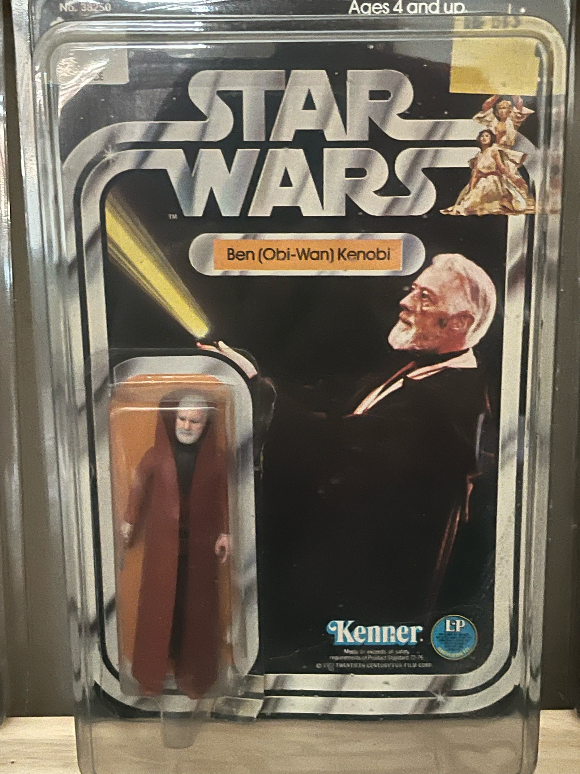 A display case with a package of Harry Potter-themed vegan butterbeer-flavored lip balm, featuring a picture of a smiling older man with white hair and glasses, and text indicating it is vegan and made in the USA.