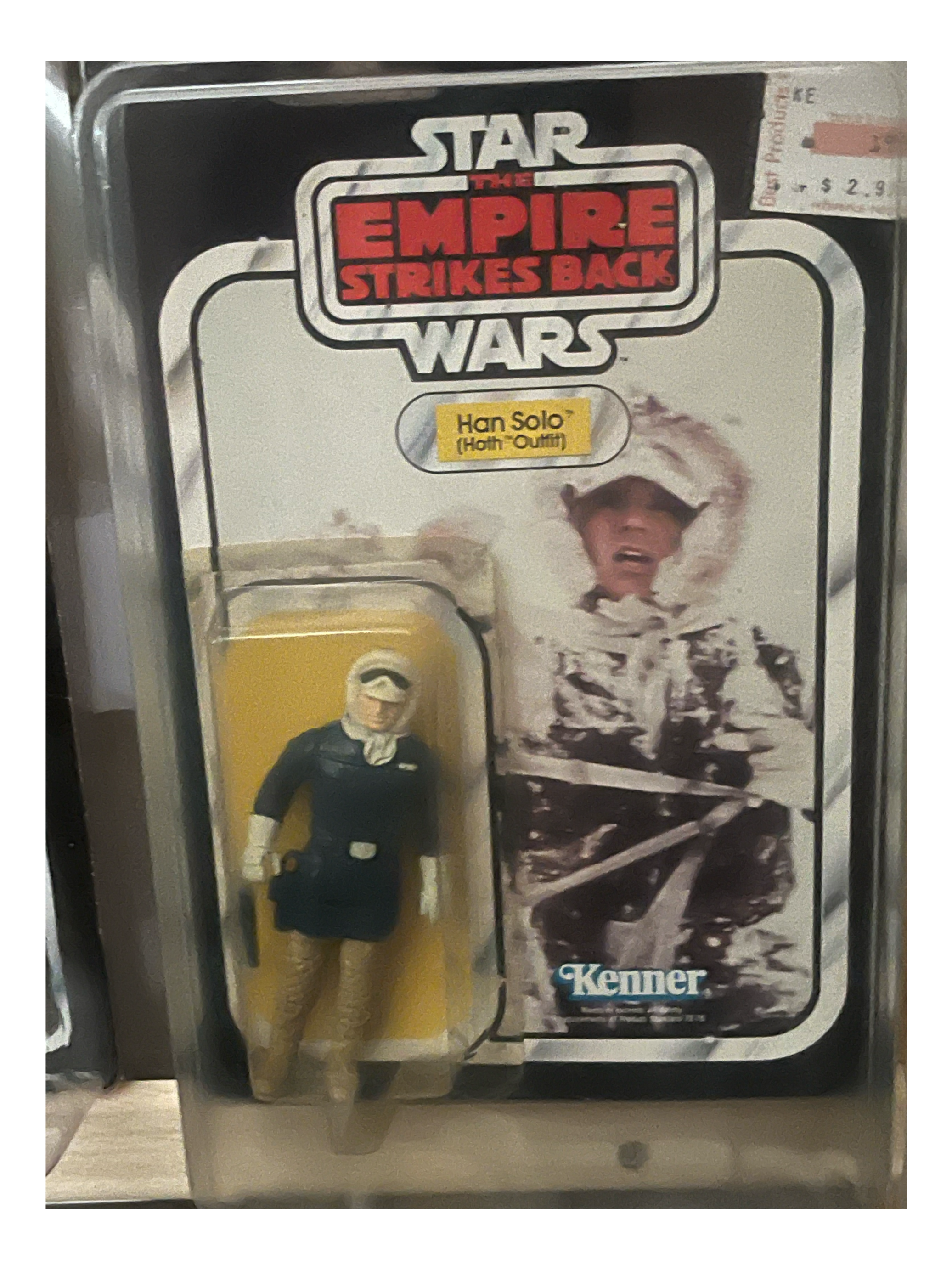 A vending machine with a capsule toy section, featuring a sticker of a person in costume and a partially visible caption, along with some text and price labels.
