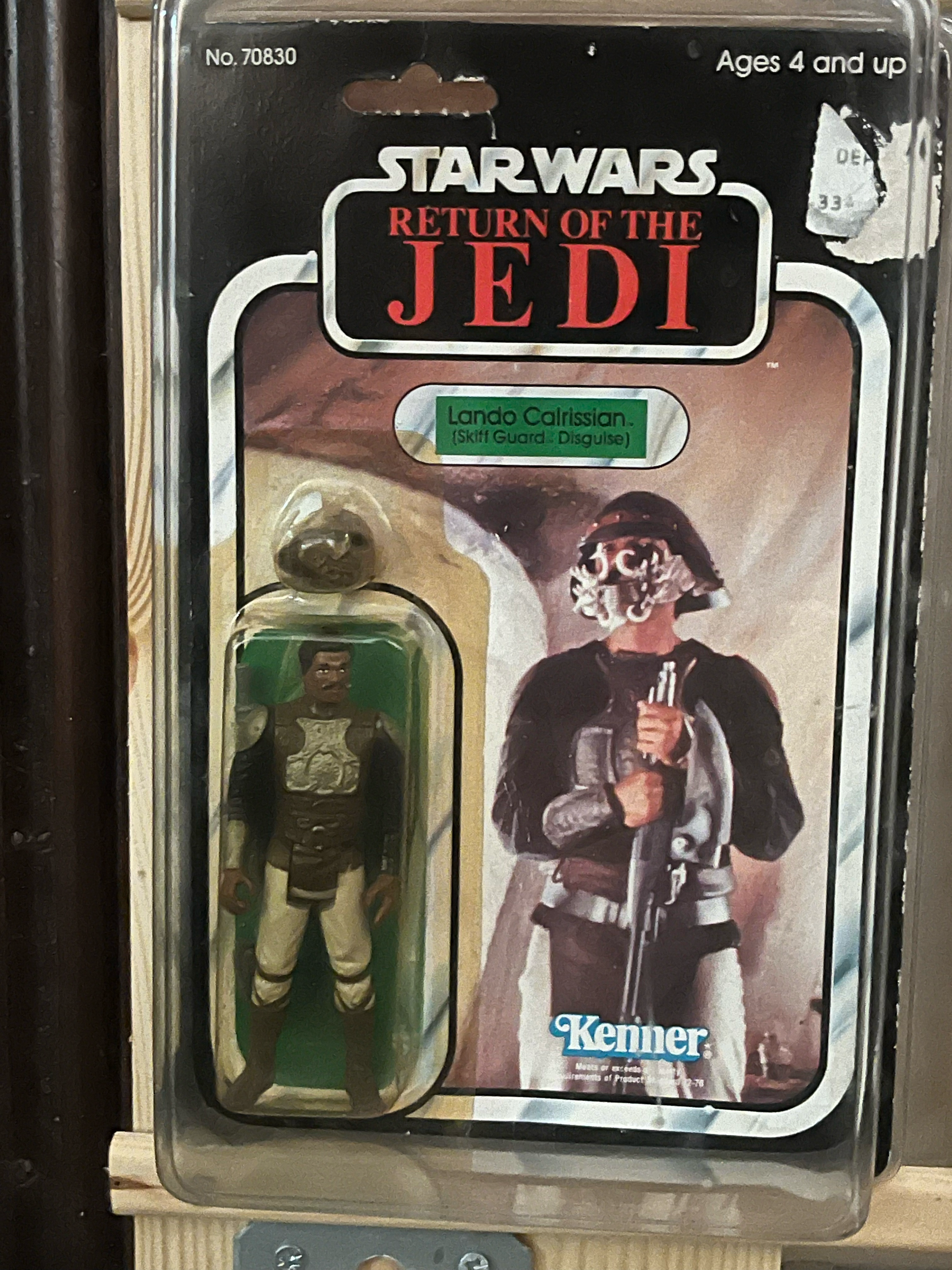 Packaging of a Jurassic World themed toy or collectible, featuring a character in ninja attire holding a sword, with a background scene from the Jurassic World franchise, including a dinosaur.