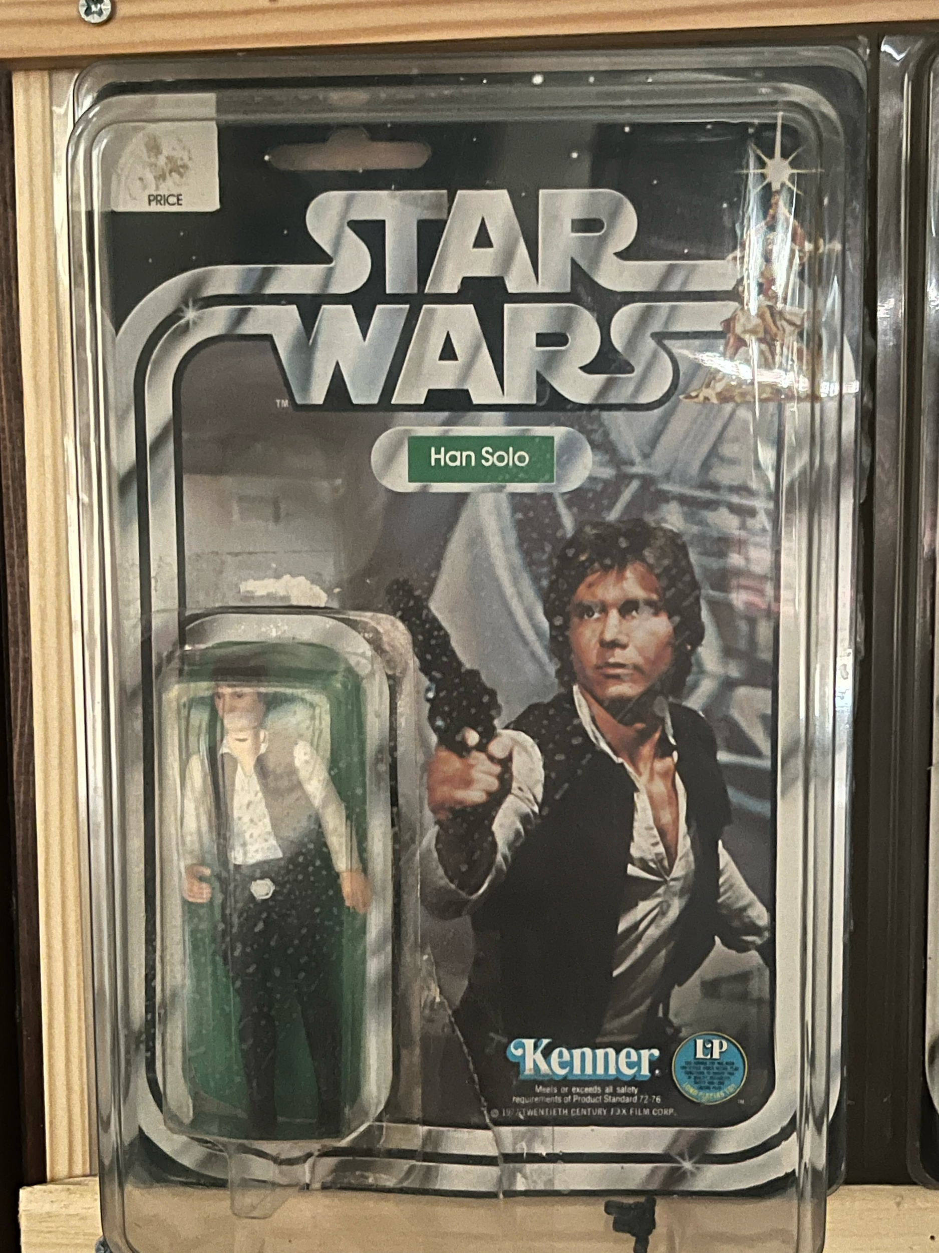 The image shows a vending machine featuring the Star Wars character Han Solo from the movie 'Solo.' The vending machine has a picture of Han Solo, a young man with brown hair, wearing a white shirt and a black vest. There is a blue and white circular