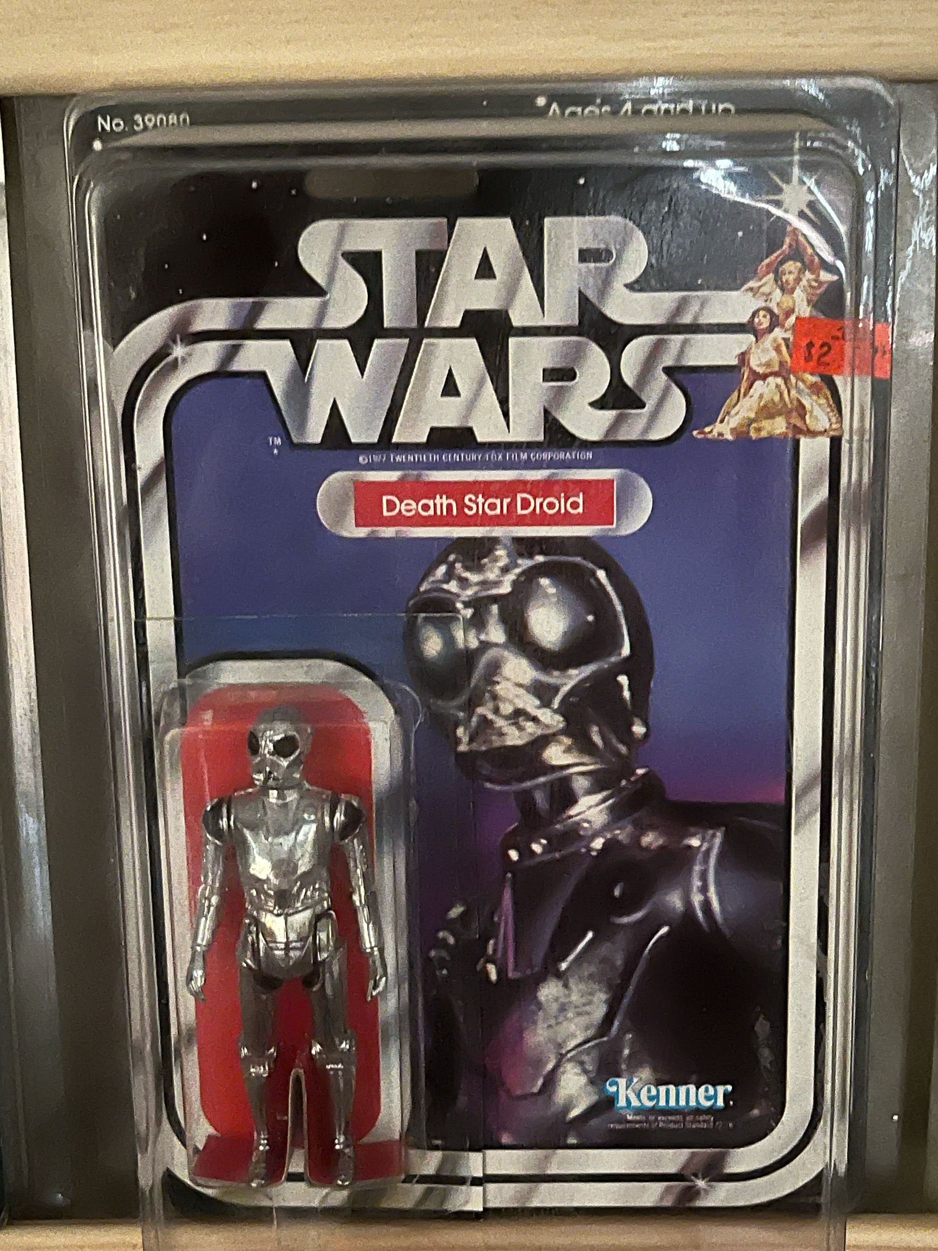 A set of stainless steel utensils including a fork, spoon, and knife in a plastic holder, inside a clear plastic display case, with a Darth Vader Star Wars themed cardboard backing featuring a skeleton character wearing a helmet.