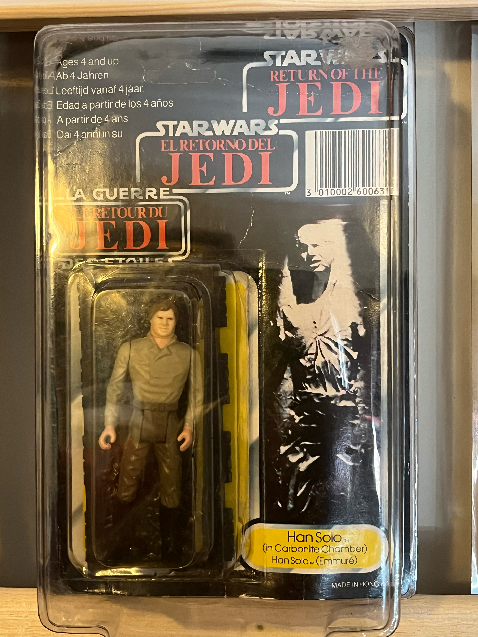 A collectible action figure of Han Solo from Star Wars in original packaging, with a dark background and yellow label.