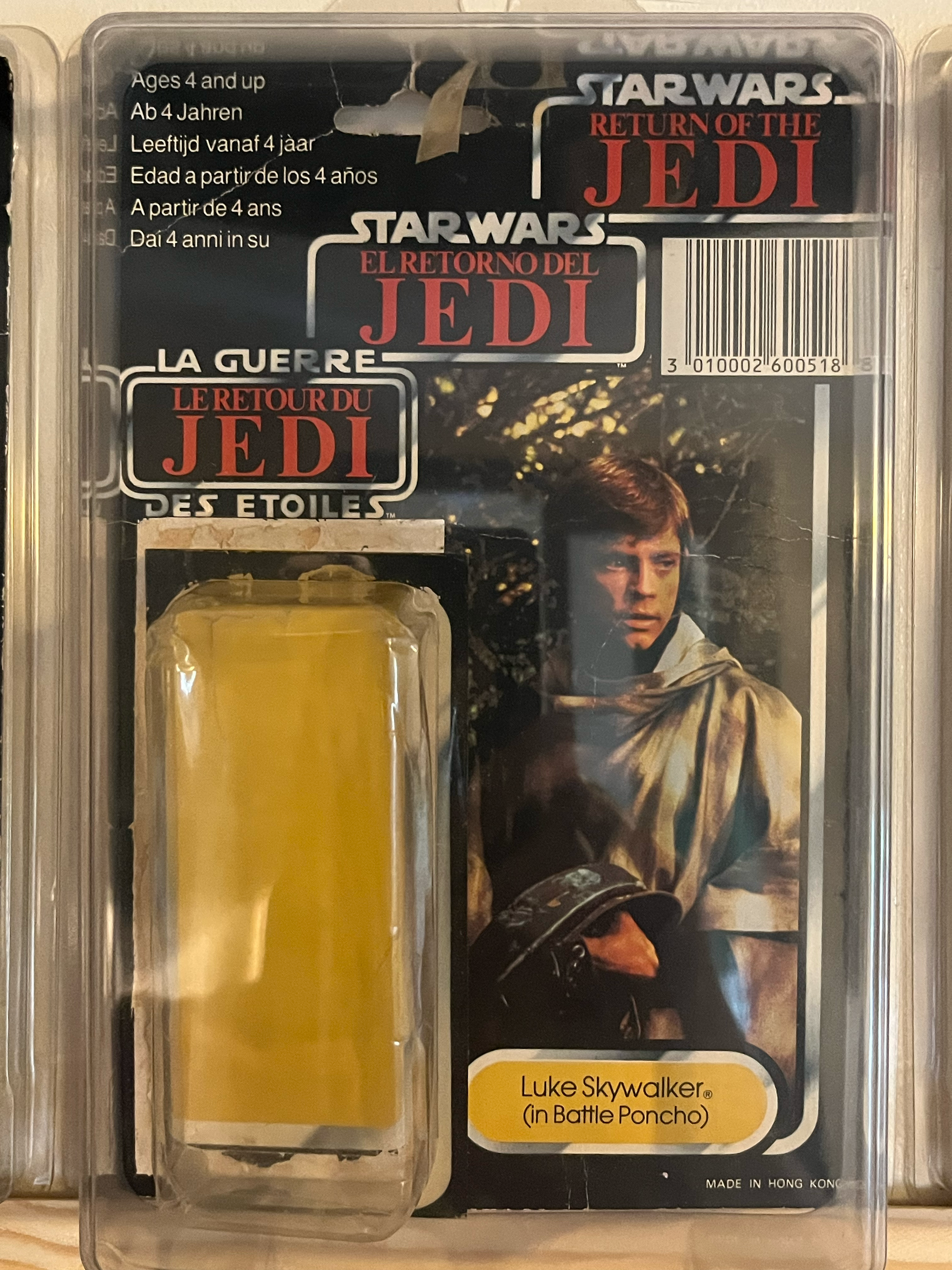 Plastic case containing yellowish liquid and a card with text and an image of a person.