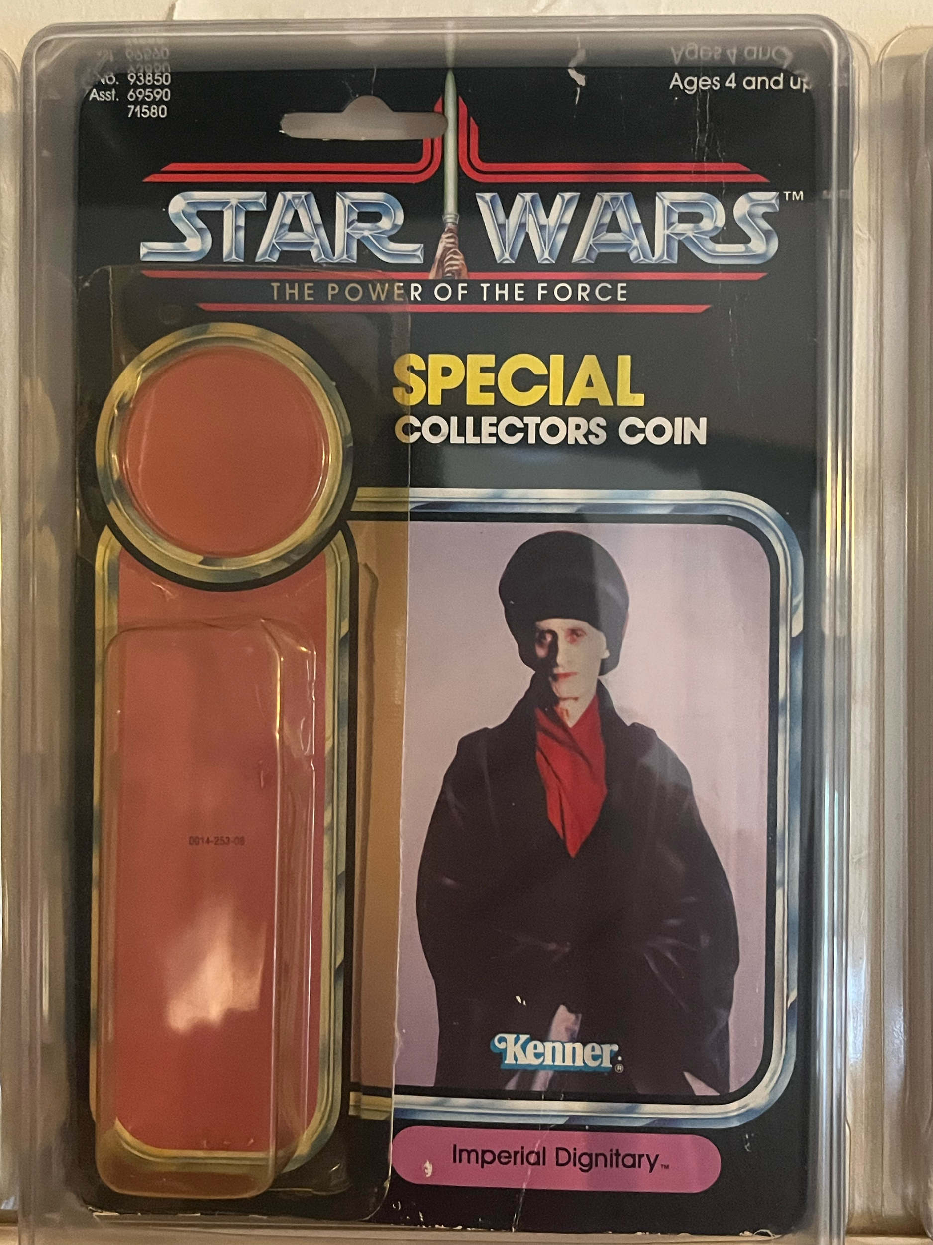 A collectible toy set featuring a character from Stone Cold Steve Austin with a black jacket, red shirt, black hat, and sunglasses, in original packaging with a black background. Contains round colored objects or tokens.