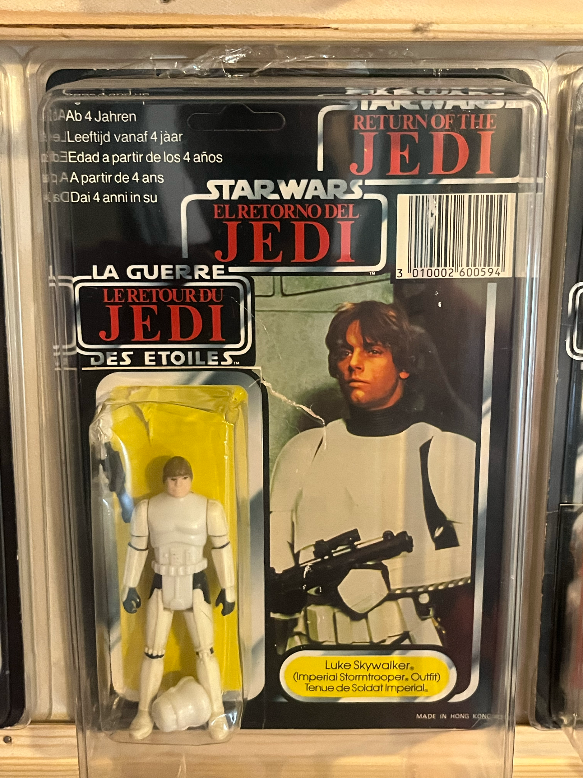A preserved action figure of Luke Skywalker in Imperial Stormtrooper uniform from Star Wars, in its original packaging with yellow label.