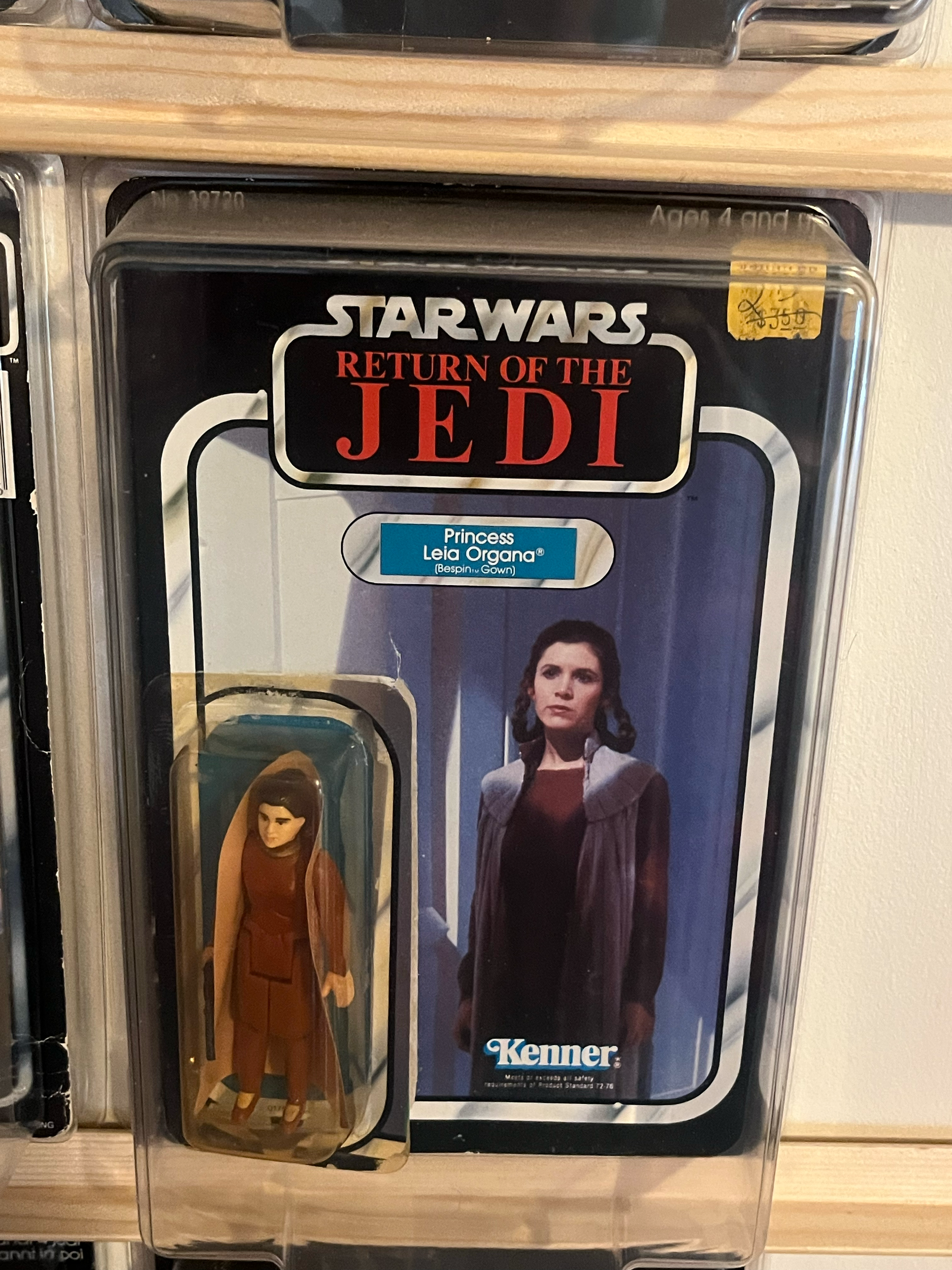 A plastic container with a 'Star Wars' themed label, featuring Princess Leia from Star Wars, on a wooden surface.