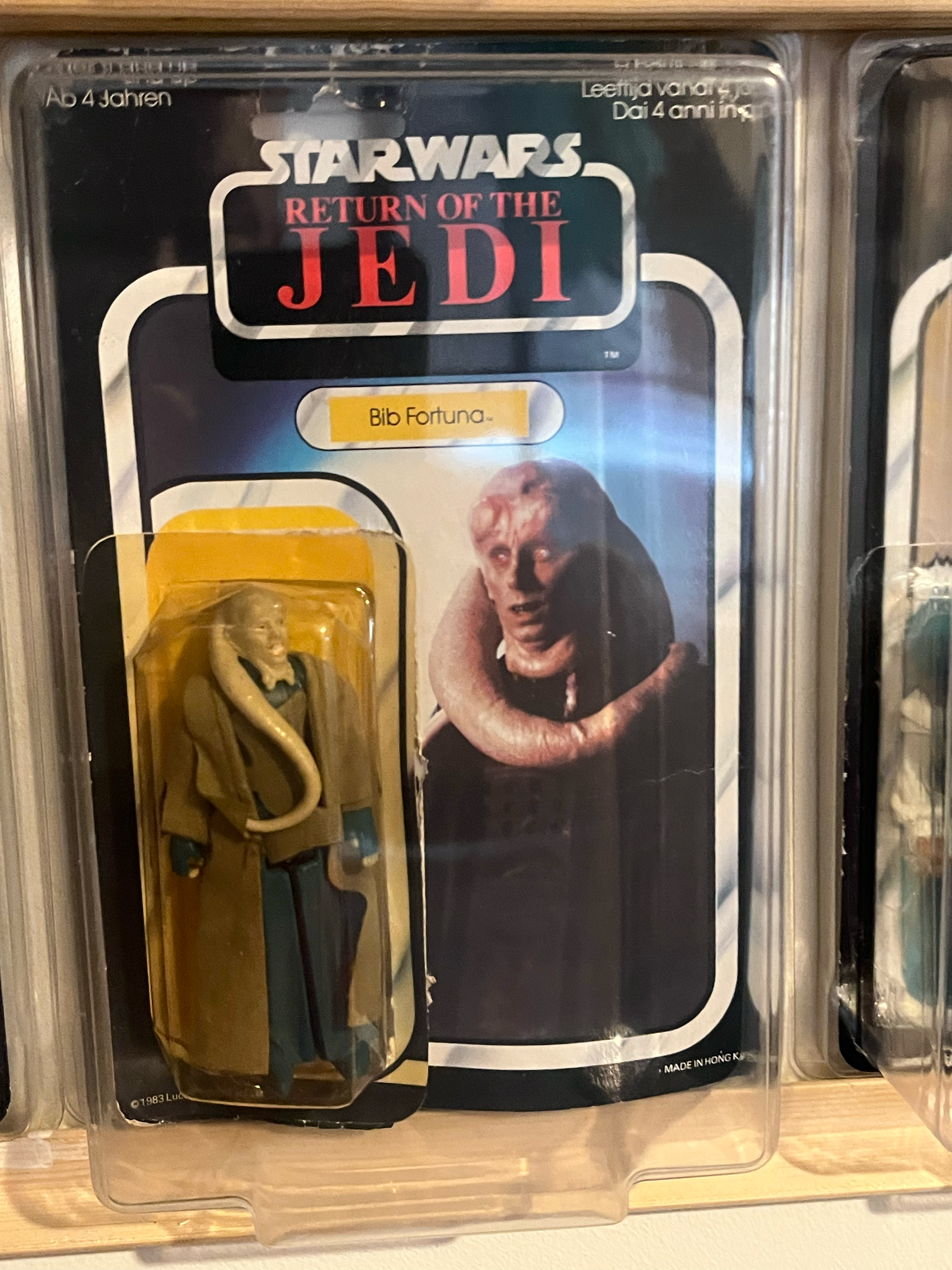 Close-up of a packaged DVD titled 'Star Wars: The Empire Strikes Back' with a picture of a woman in a black dress on the cover. The DVD case is in plastic wrapping, and part of a brass-colored object is visible at the bottom of the image.