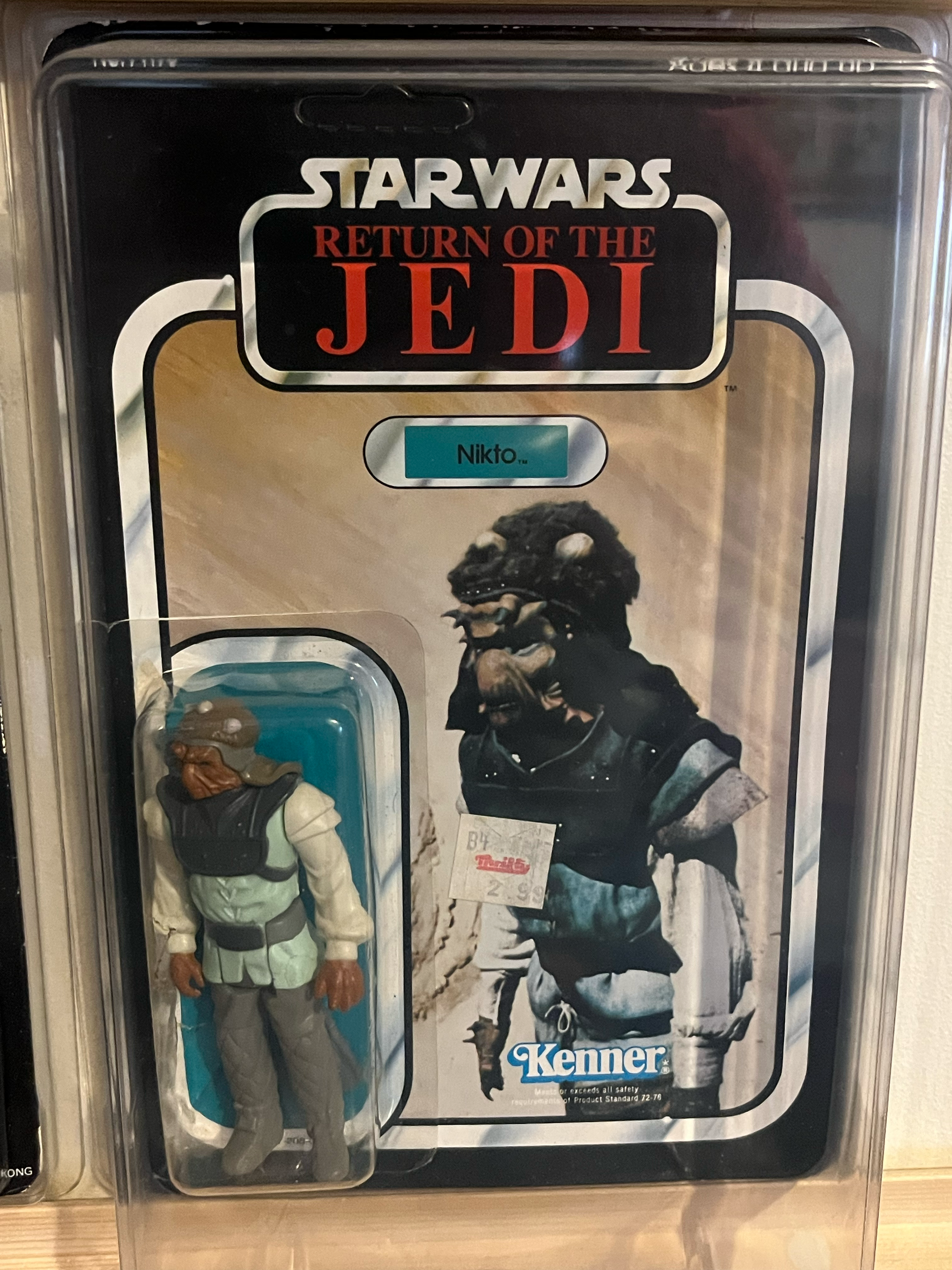 A collection of action figures including characters from Star Wars, Indiana Jones, and Marvel, stored in a clear plastic container.