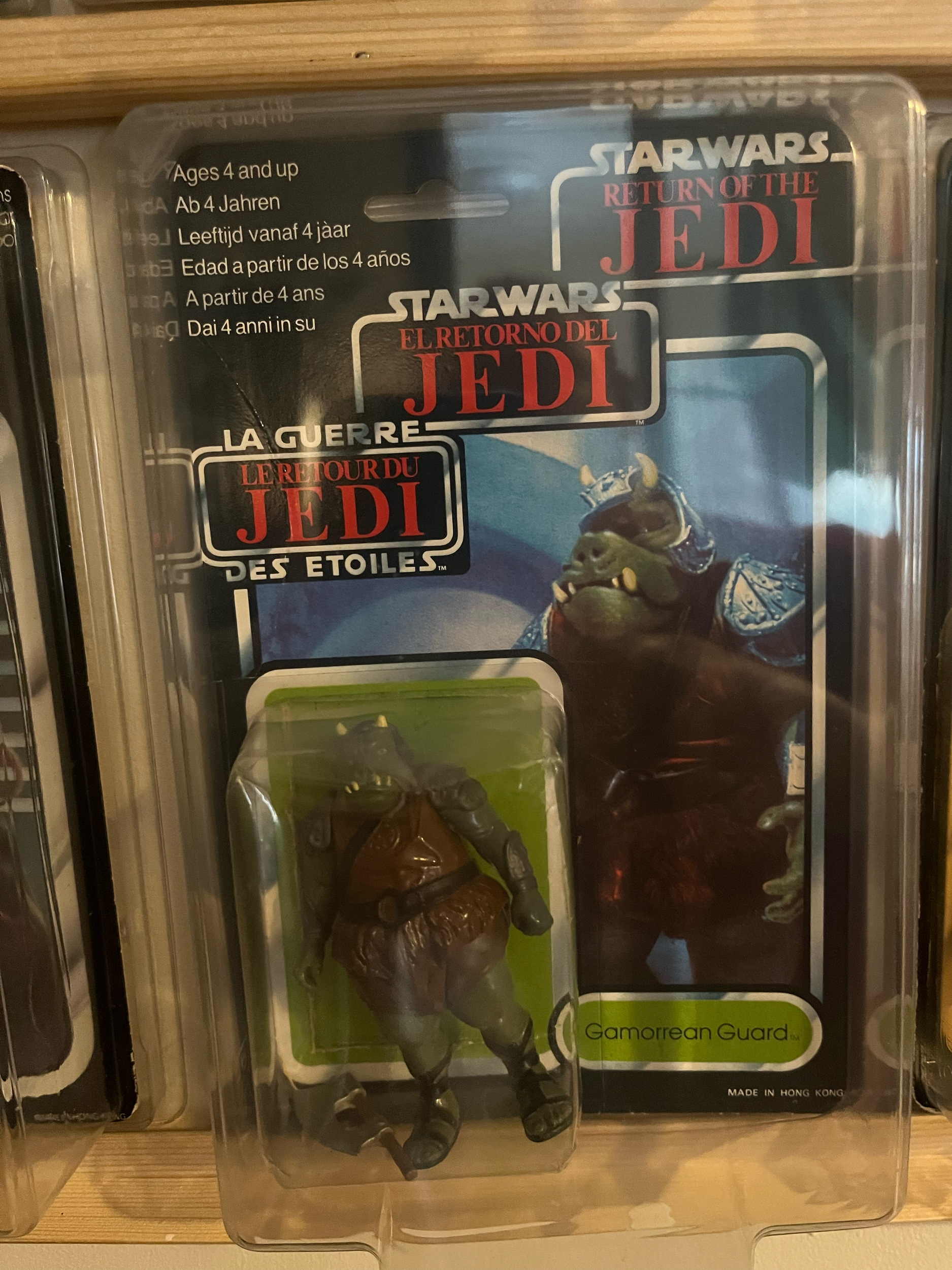 A clear plastic case containing a Star Wars action figure of Jabba the Hutt with a green label that reads 'Gormorread Guard' and some original text from the packaging.