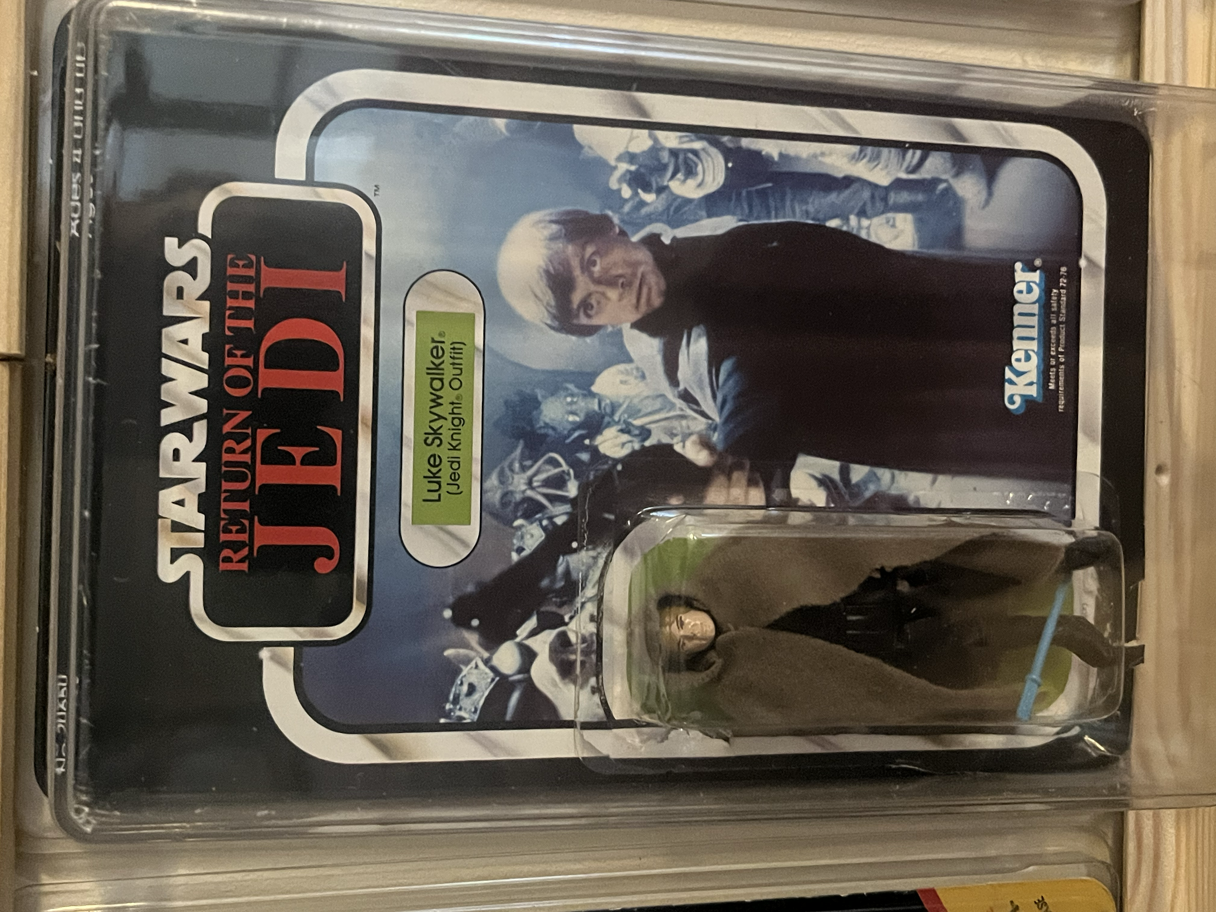 A framed action figure of Luke Skywalker from Star Wars Episode V: The Empire Strikes Back in an acrylic display case
