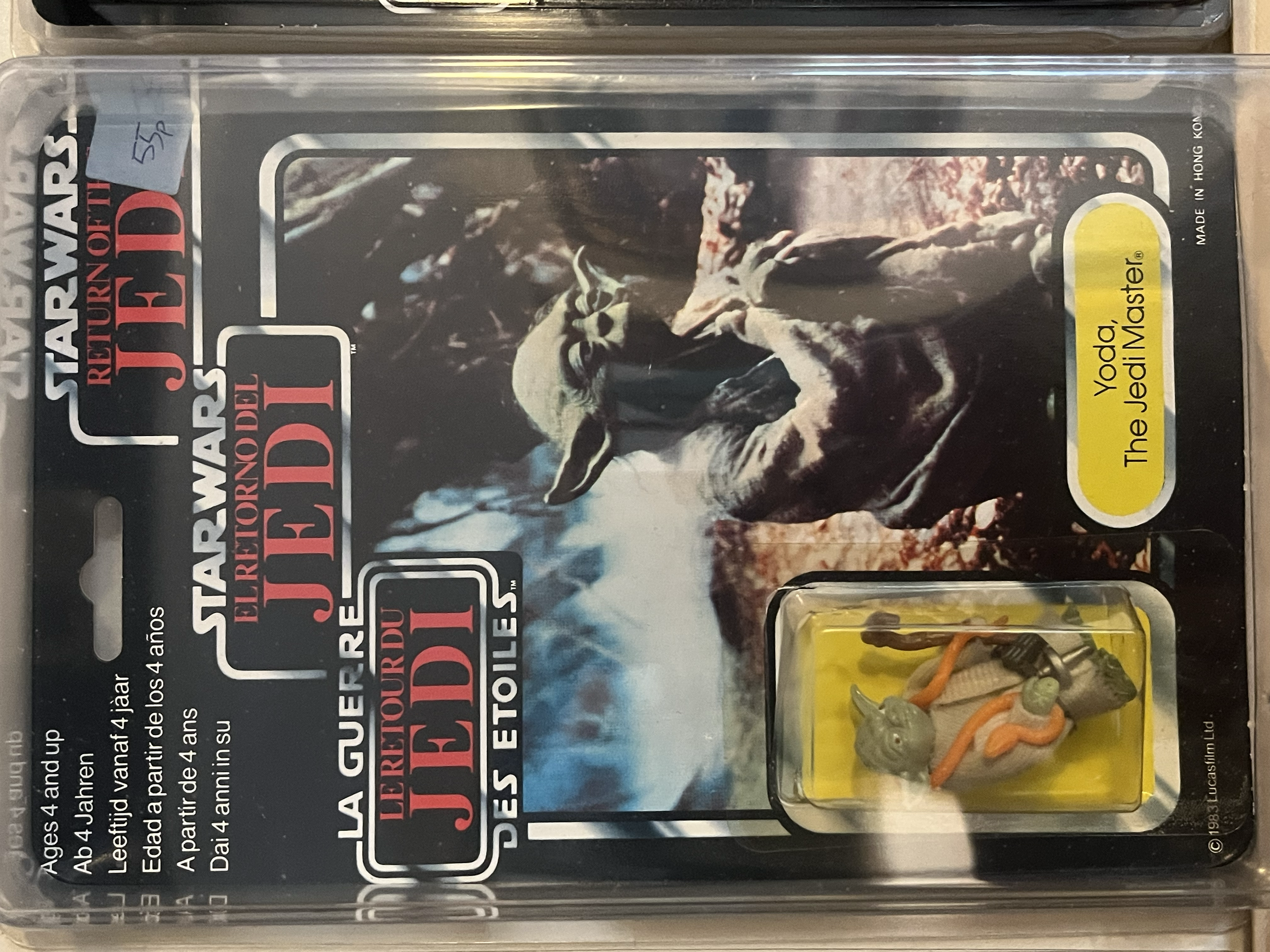 Close-up of a toy action figure resembling a rat or rodent, with accessories including a miniature snake and snake-like toy, inside clear plastic packaging.