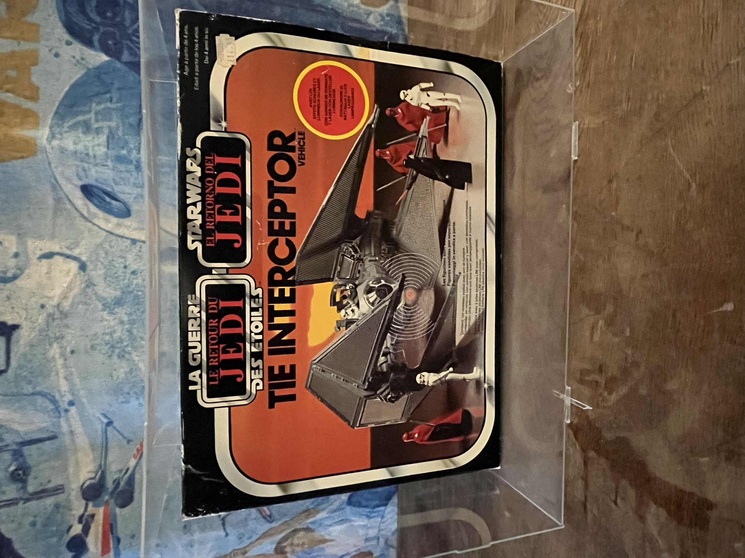 A vintage toy in original packaging featuring a futuristic car and a robot, with bold text and vibrant colors on the box.