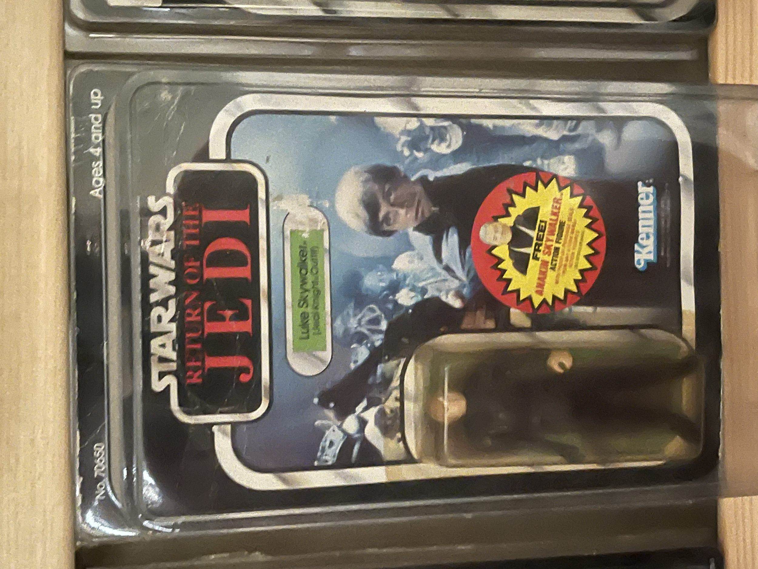 A DVD case for the movie 'Mad Max: Fury Road' featuring the character Mad Max. The cover shows a man with a beard and sunglasses, with a masked woman. The case has various stickers and labels, including a red and yellow one that says 'Special Edition