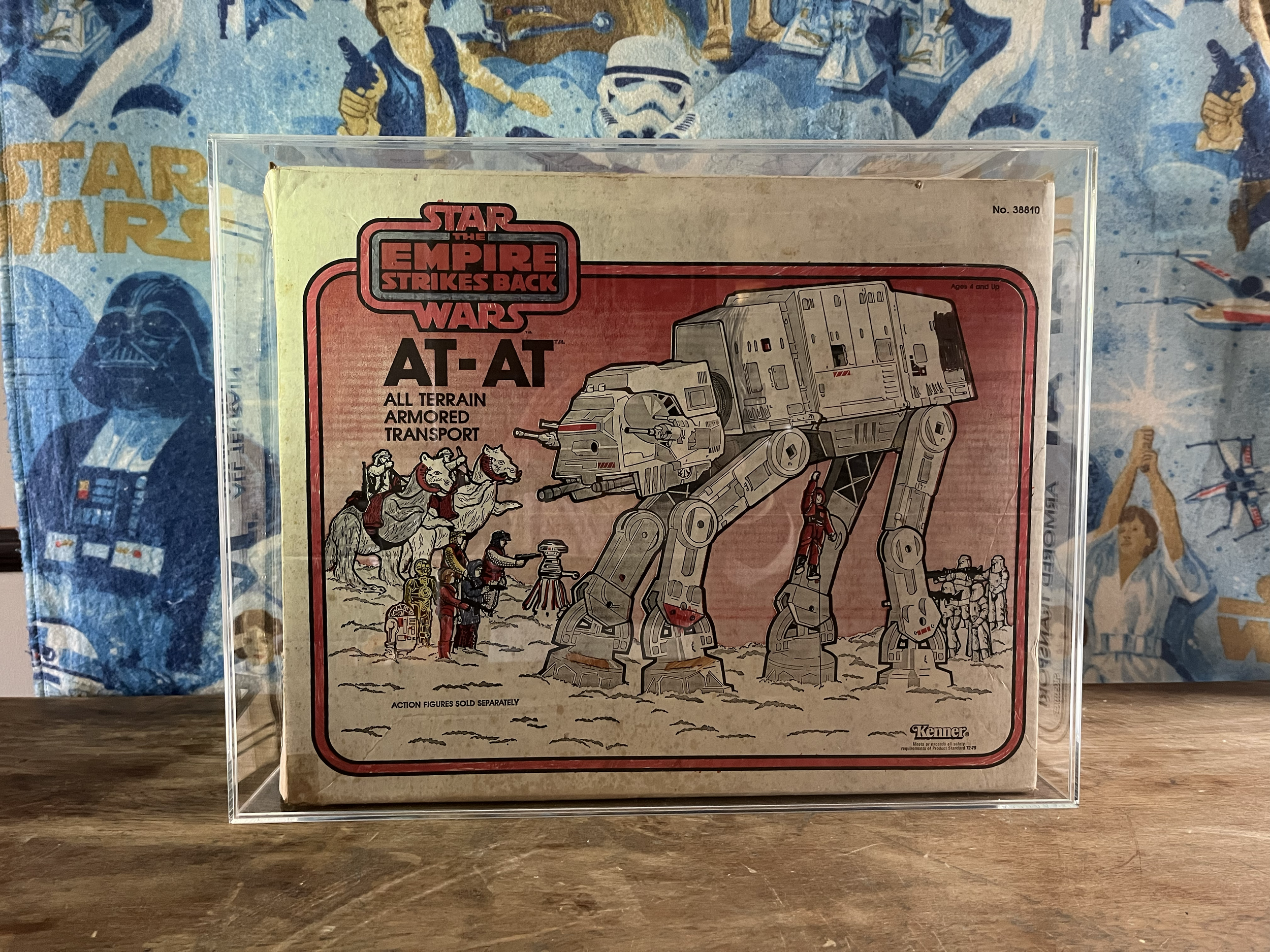Star Wars The Empire Strikes Back action figure packaging of a large AT-AT Walker, featuring a handle with multiple figures riding and shooting, set against a background with star wars-themed posters.
