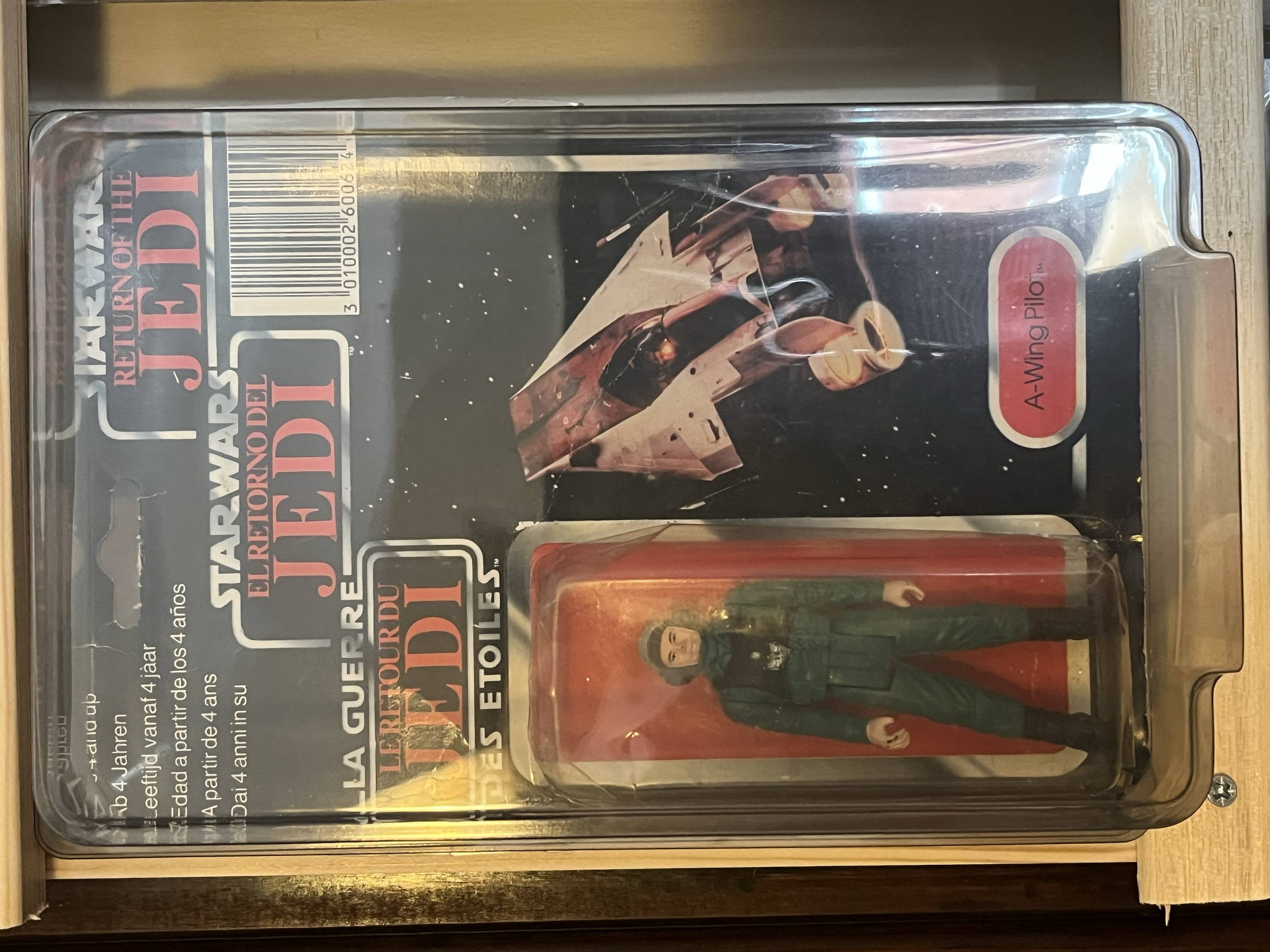A display case containing action figures from the movie 'Star Wars: The Empire Strikes Back,' including a figure of Han Solo dressed as Han Solo in Princess Leia's gown.