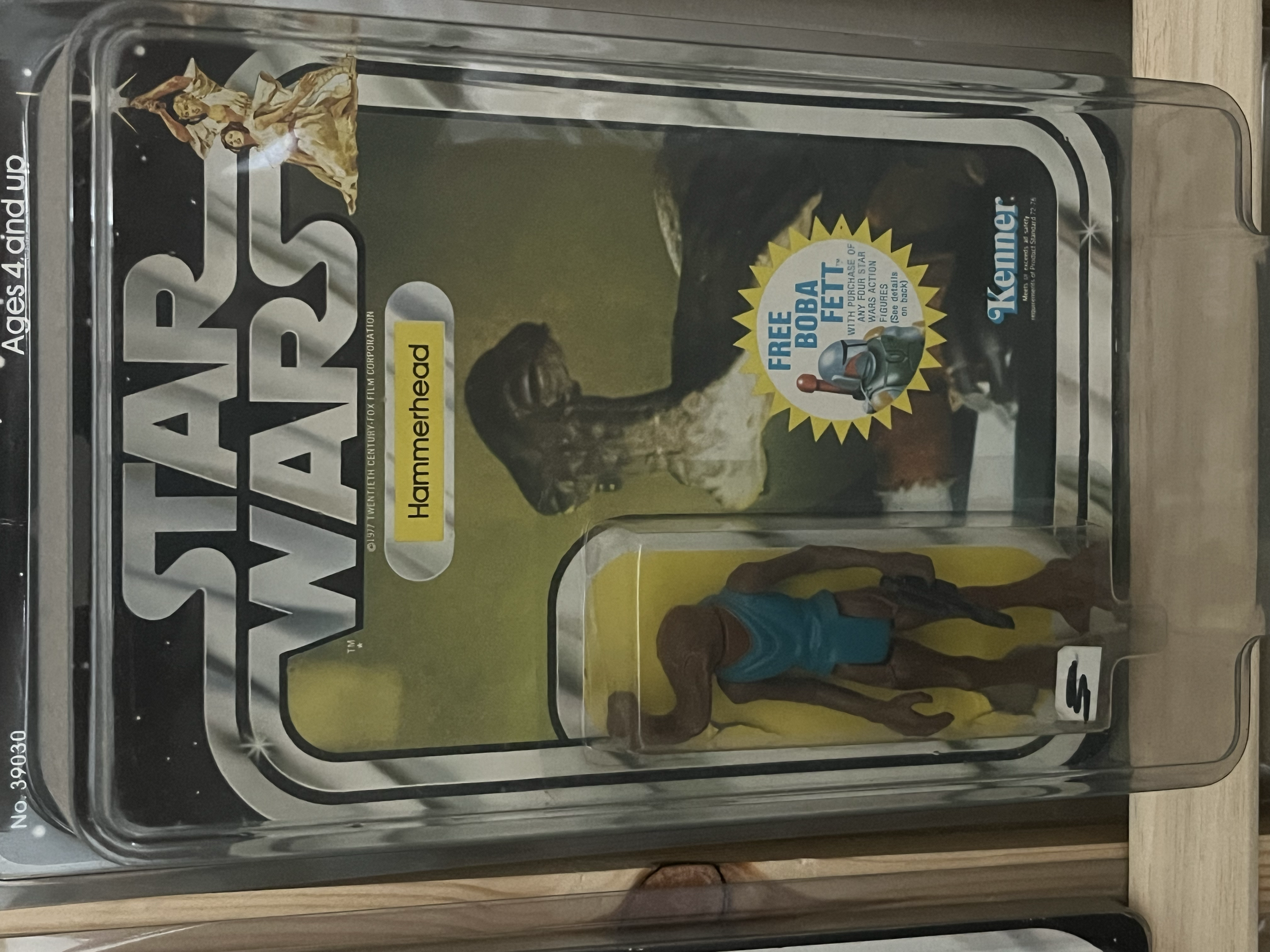 A vintage Star Wars action figure display case with characters from the original series, including a Jabba the Hutt figure and other figures in standing poses.
