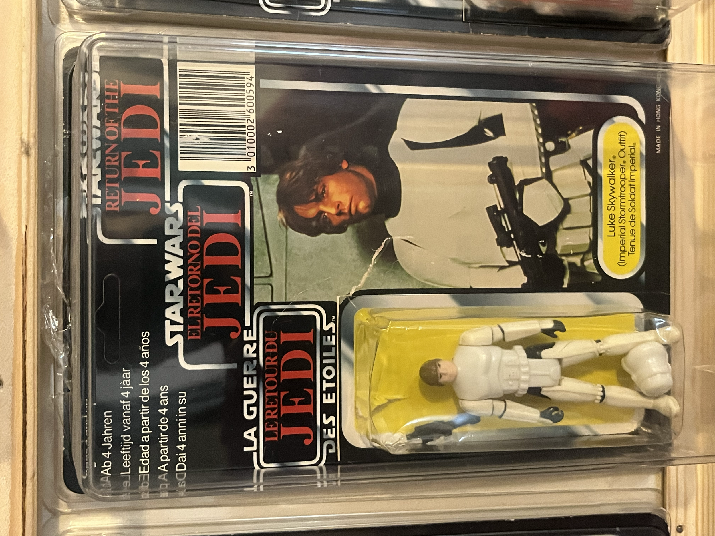 A preserved action figure of Luke Skywalker in Imperial Stormtrooper uniform from Star Wars, in its original packaging with yellow label.