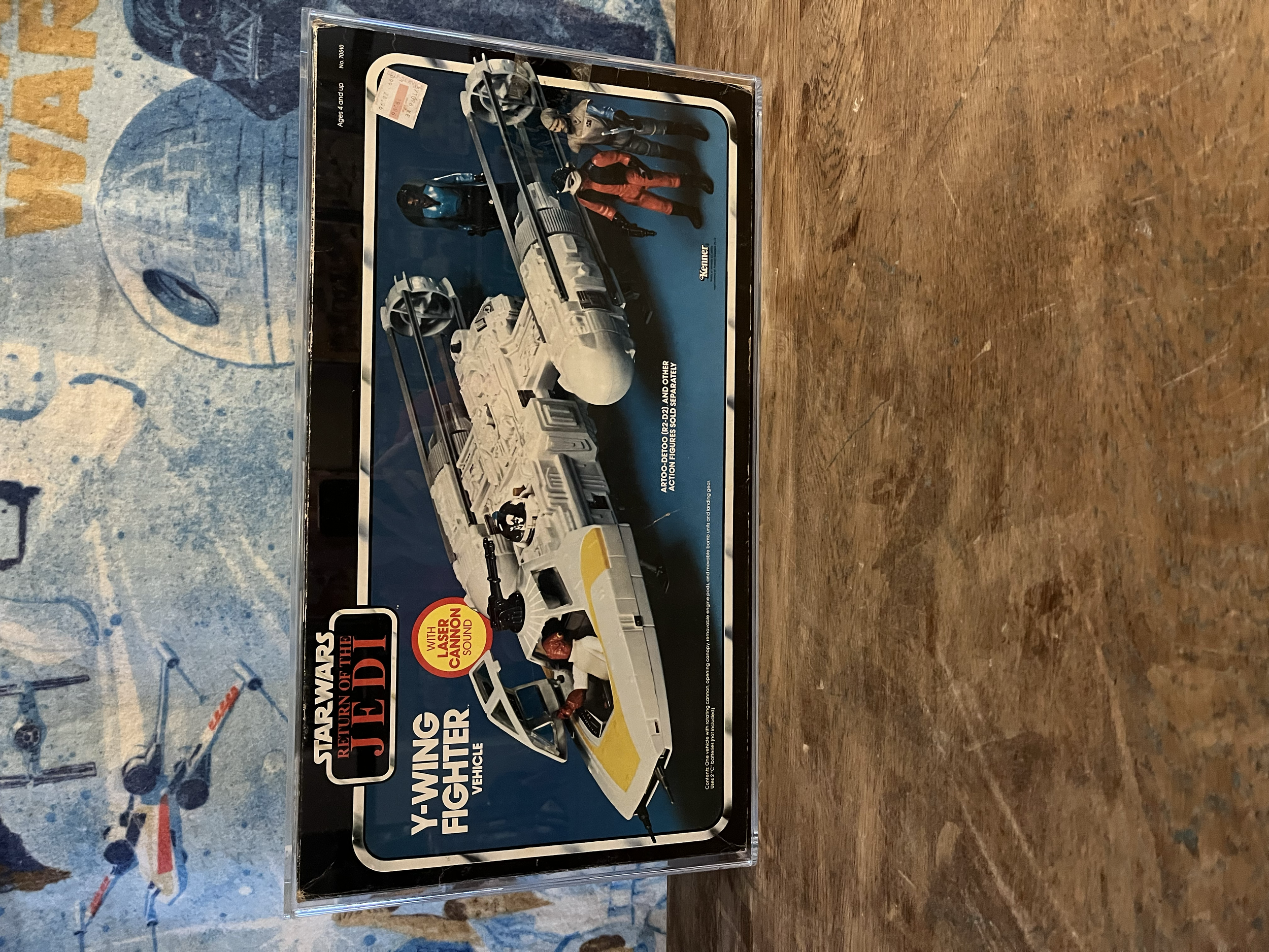 A vintage Star Wars Return of the Jedi warning sign warning of fighting, shattering, and vehicular damage. The sign features characters from the Star Wars franchise, including action figures and a spaceship. The sign emphasizes sound effects, with a 