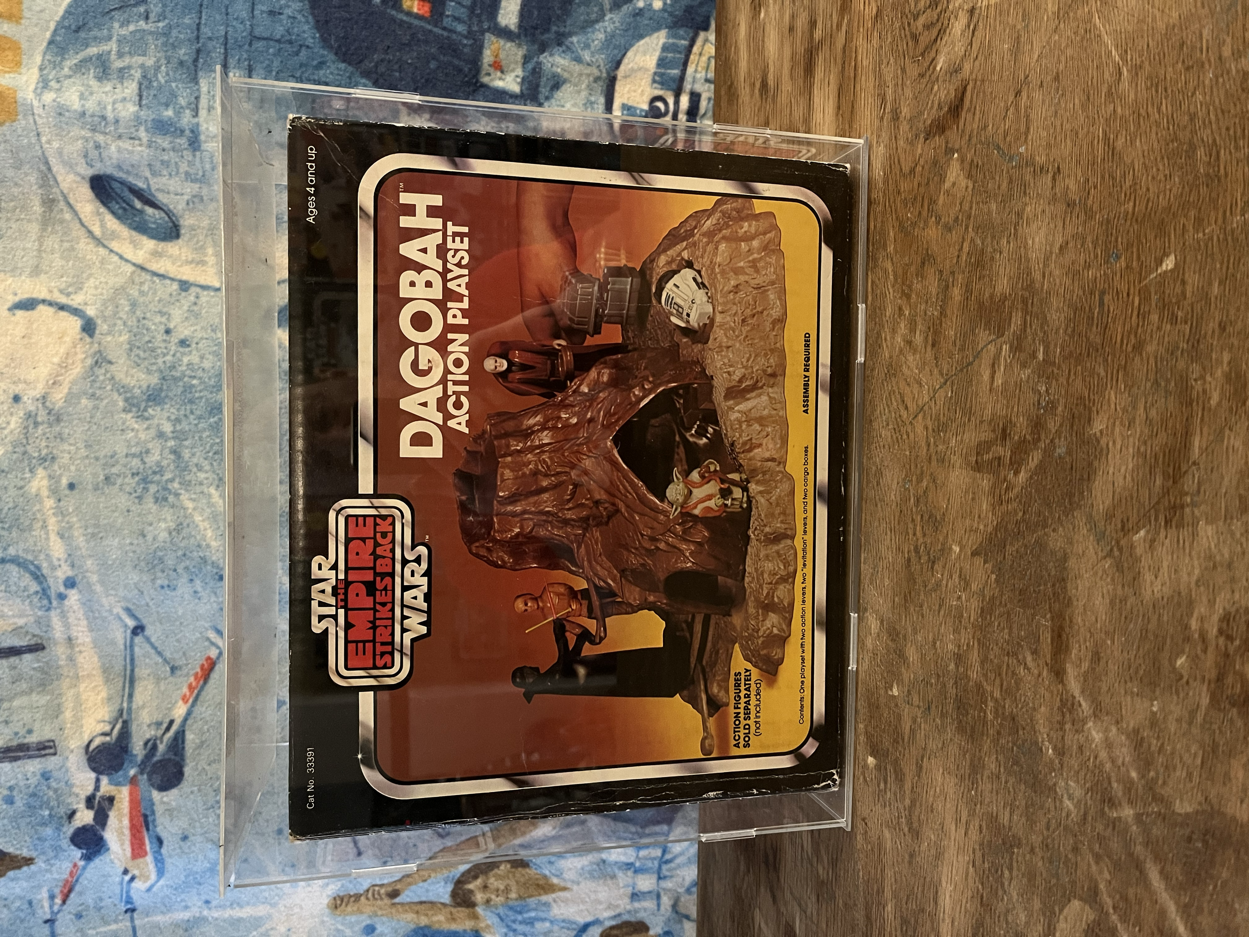 The image shows a boxed set of Star Wars action figures titled "Star Wars Empire Strikes Back" in a plastic display case. The box features imagery from the Star Wars universe, including a large rock formation, a character from the series, and a space