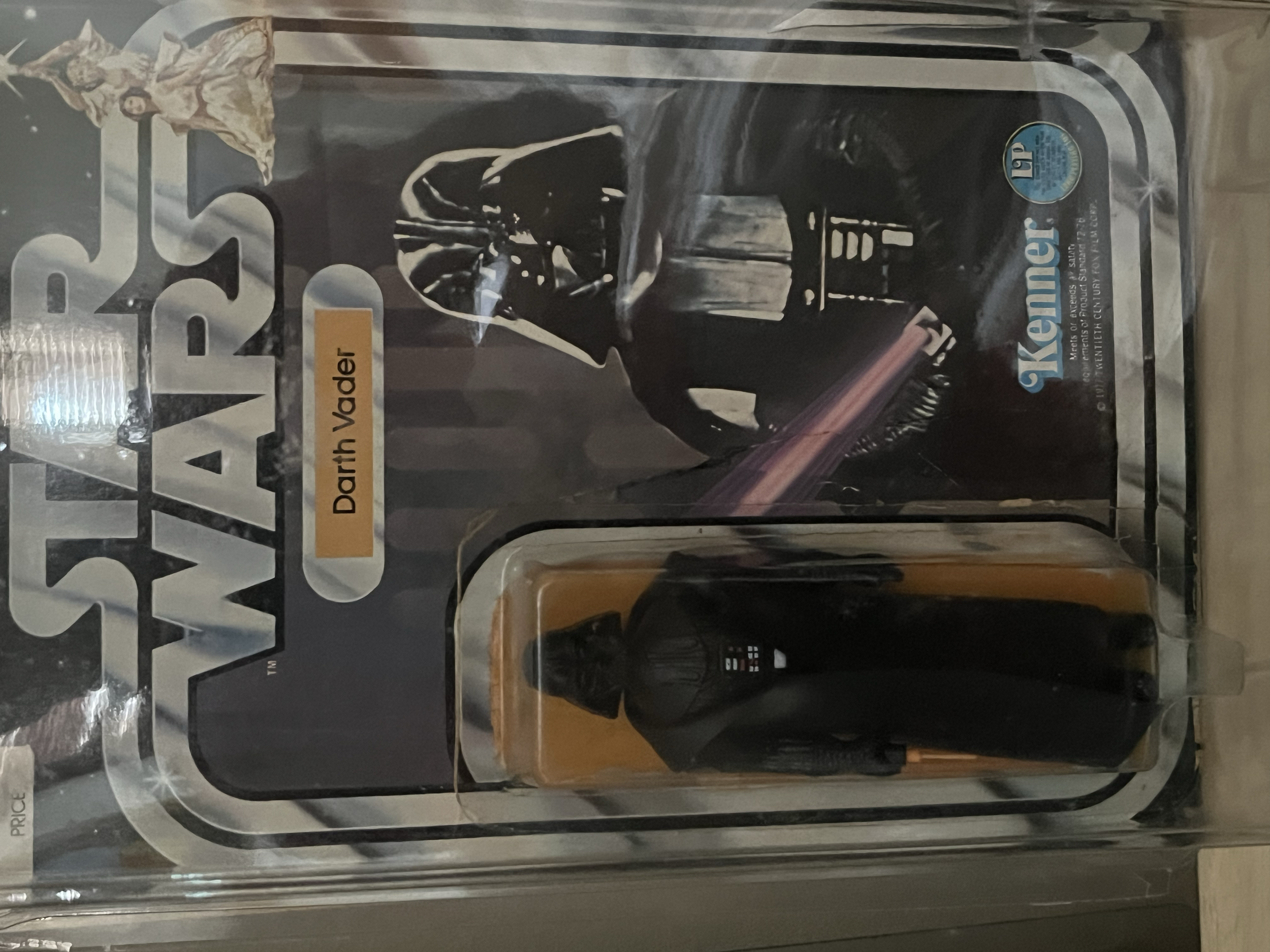 A boxed set of Darth Vader memorabilia including a Darth Vader action figure, a Darth Vader mask, and a Darth Vader lightsaber toy, all arranged in packaging with a Star Wars theme.