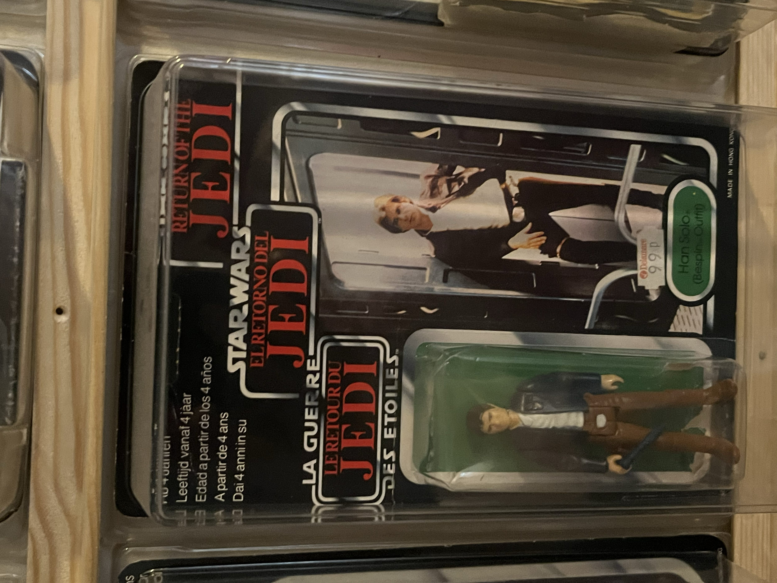 A collection of razor blades in transparent plastic packaging with a label showing an image of a man and warning messages.