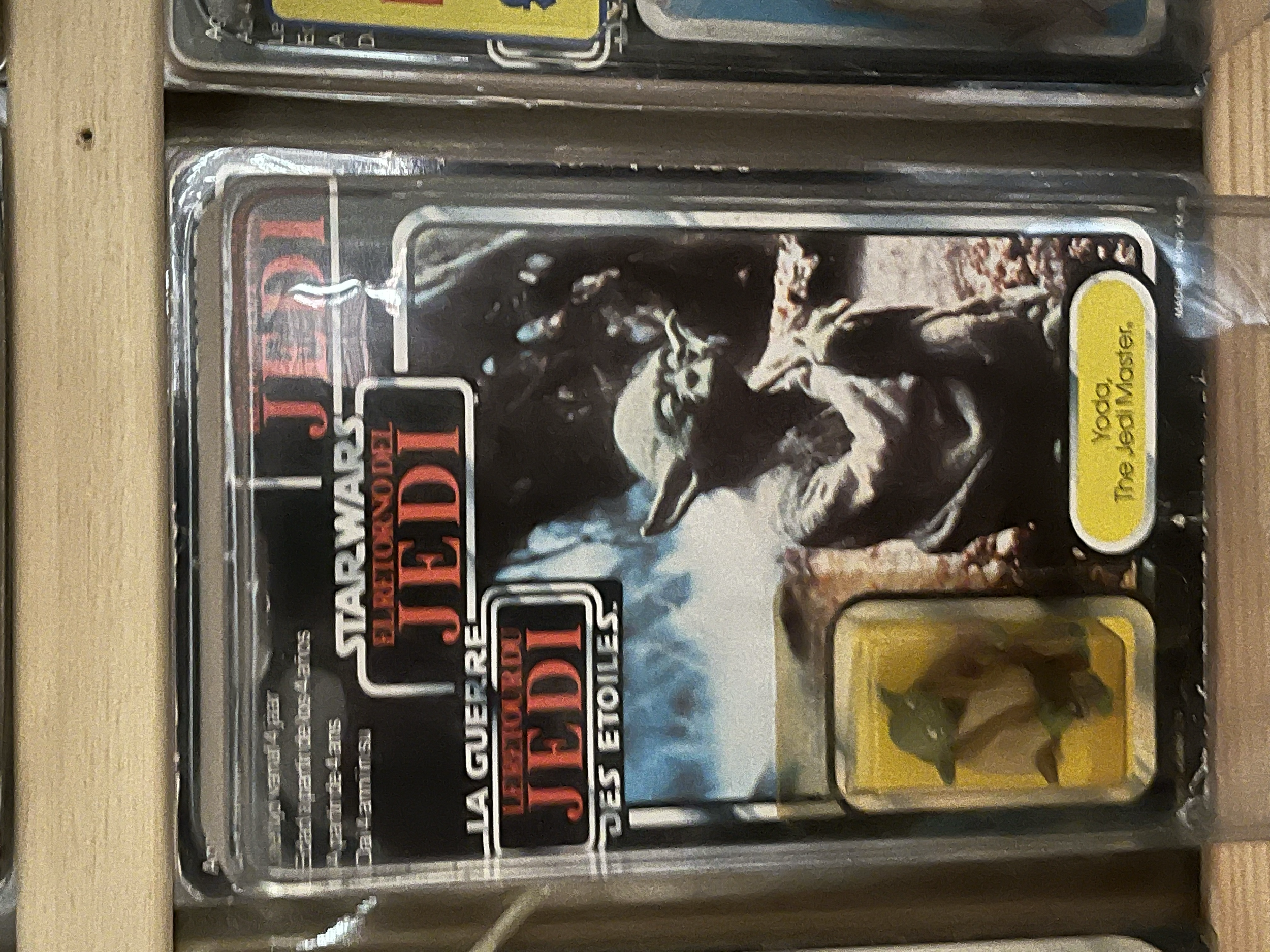Close-up of a sealed plastic case containing a video game cartridge for 'Gears of War' with a label depicting a soldier and a yellow sticker with black text.