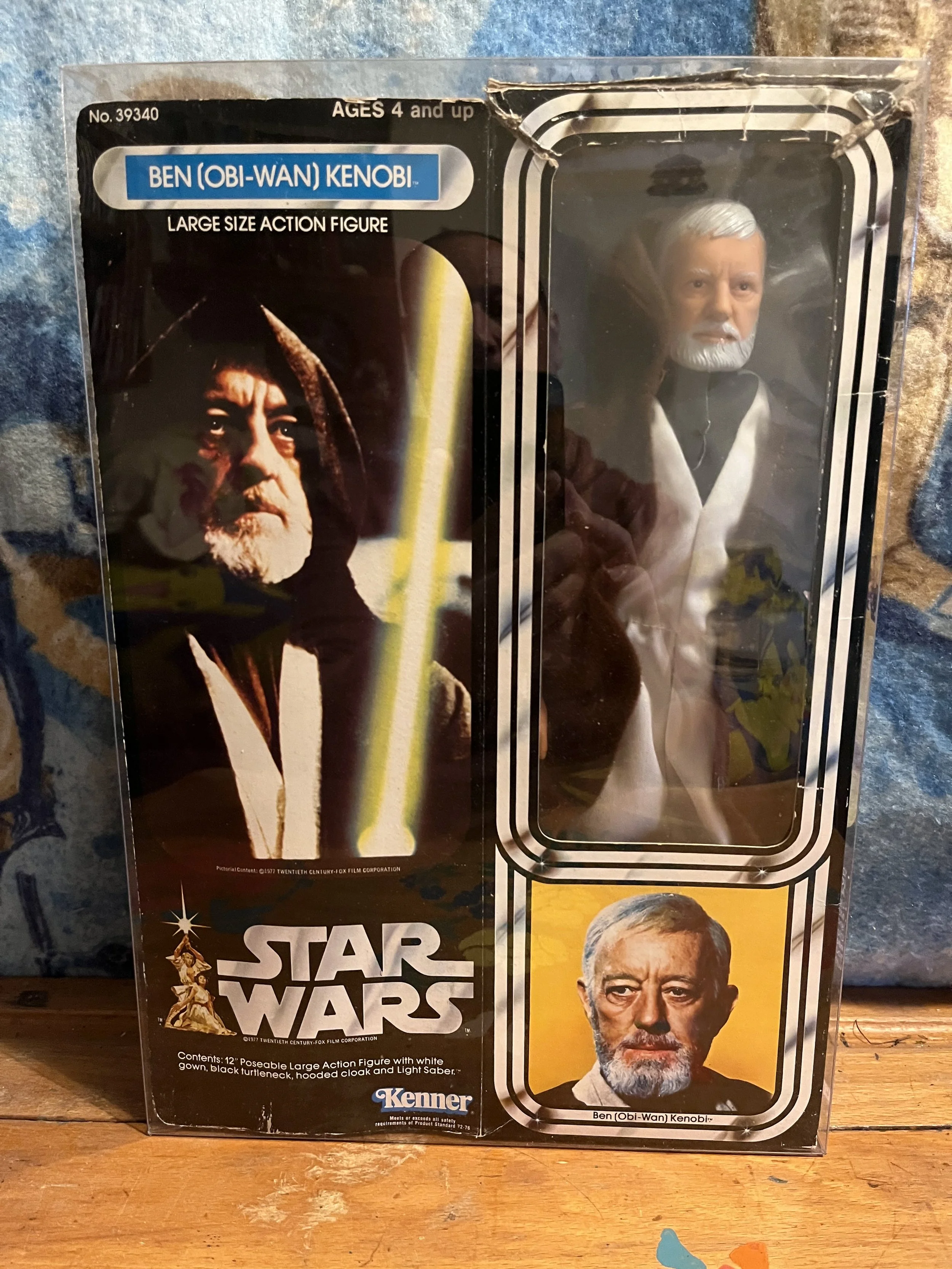Star Wars action figure packaging featuring characters Obi-Wan Kenobi and Grand Moff Tarkin, with product details and branding.