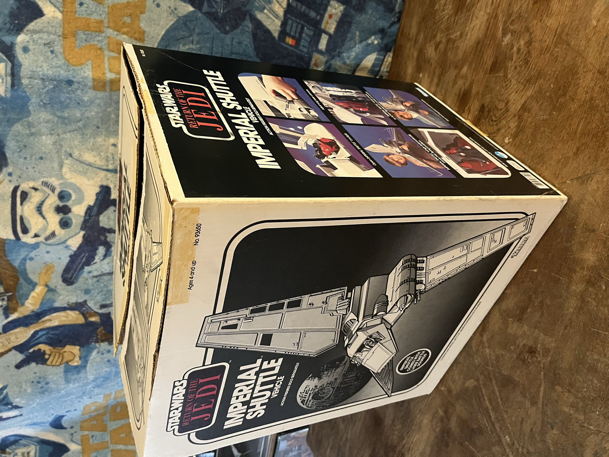 Box for a model kit of the Imperial Shuttle from Star Wars, featuring images of the assembled model, with black and white illustrations and text on the box.