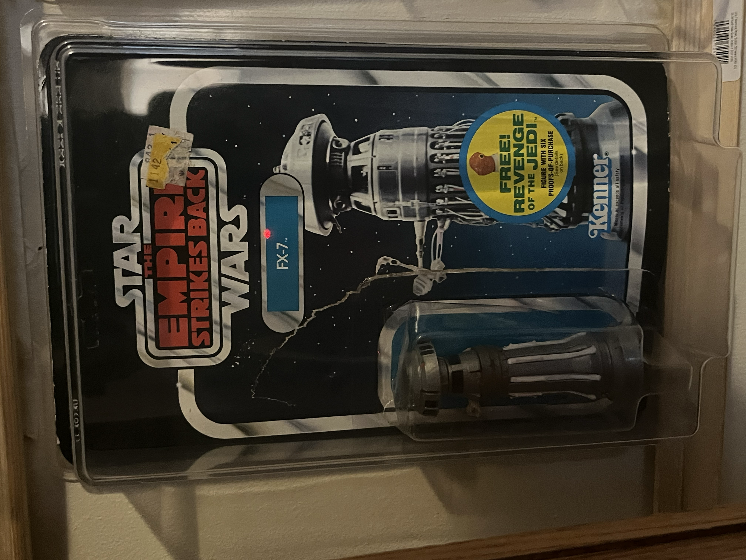 Star Wars the Empire Strikes Back collectible figure of fx7 in its original packaging with a space-themed background.
