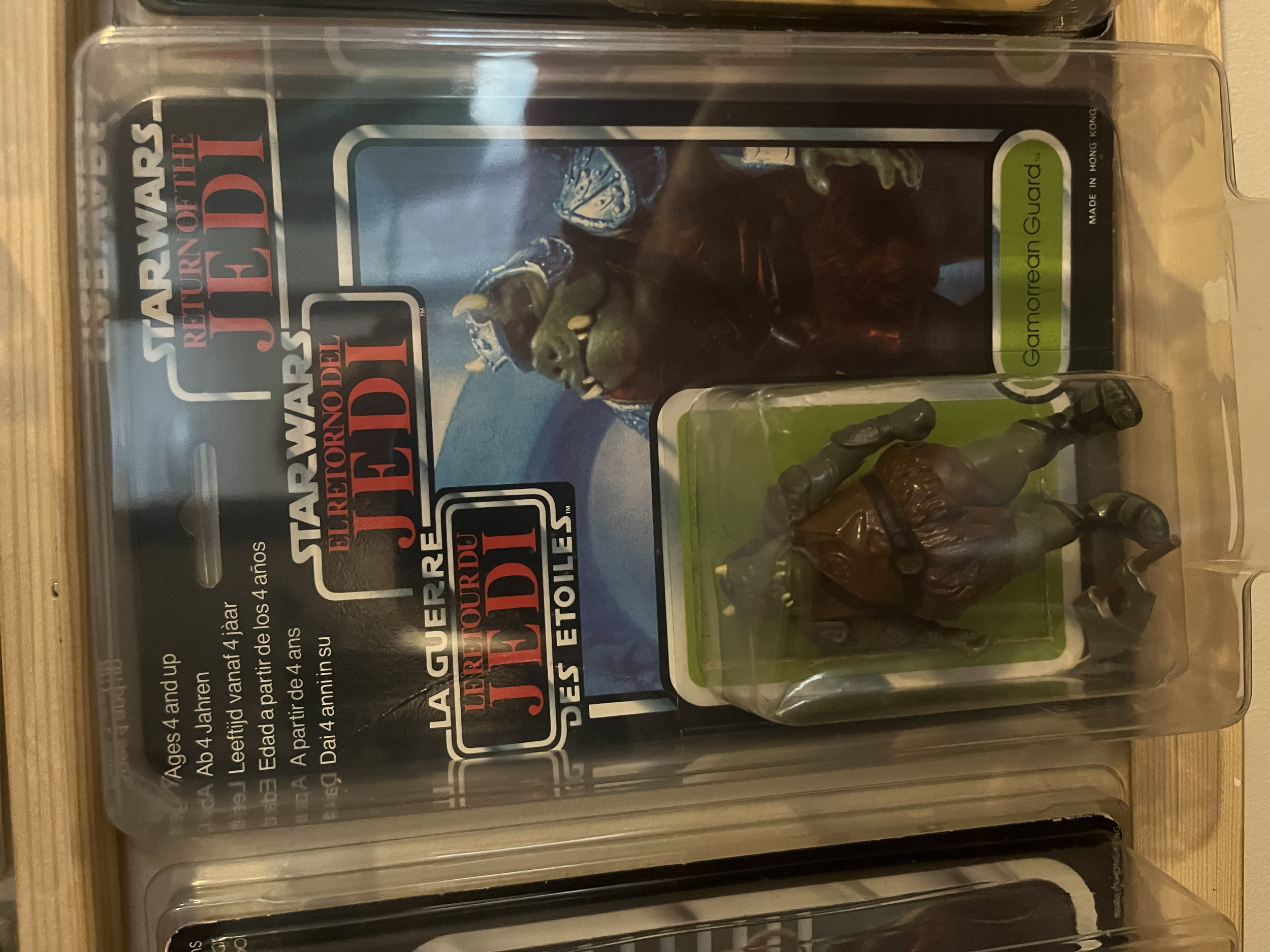 A clear plastic case containing a Star Wars action figure of Jabba the Hutt with a green label that reads 'Gormorread Guard' and some original text from the packaging.
