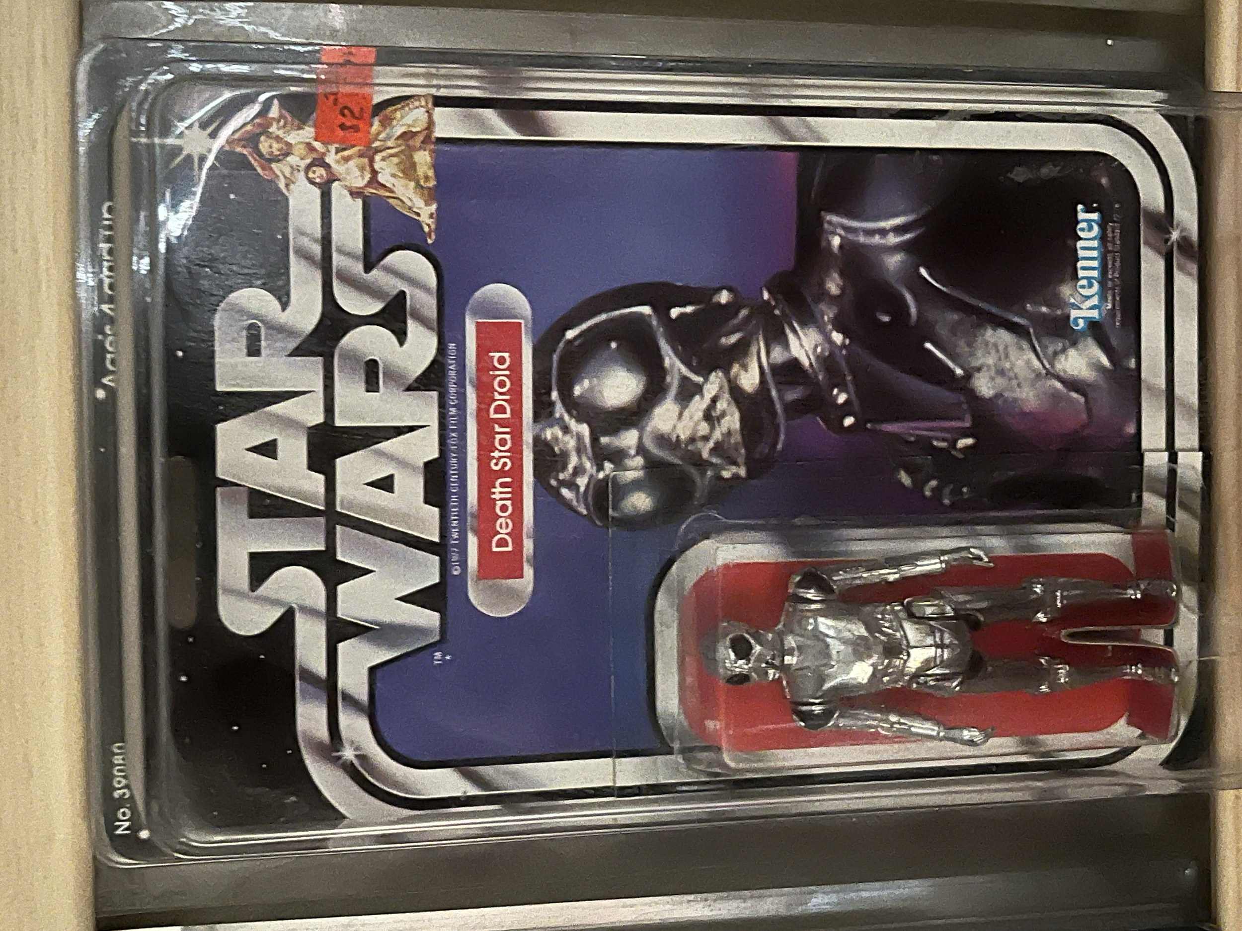 A set of stainless steel utensils including a fork, spoon, and knife in a plastic holder, inside a clear plastic display case, with a Darth Vader Star Wars themed cardboard backing featuring a skeleton character wearing a helmet.