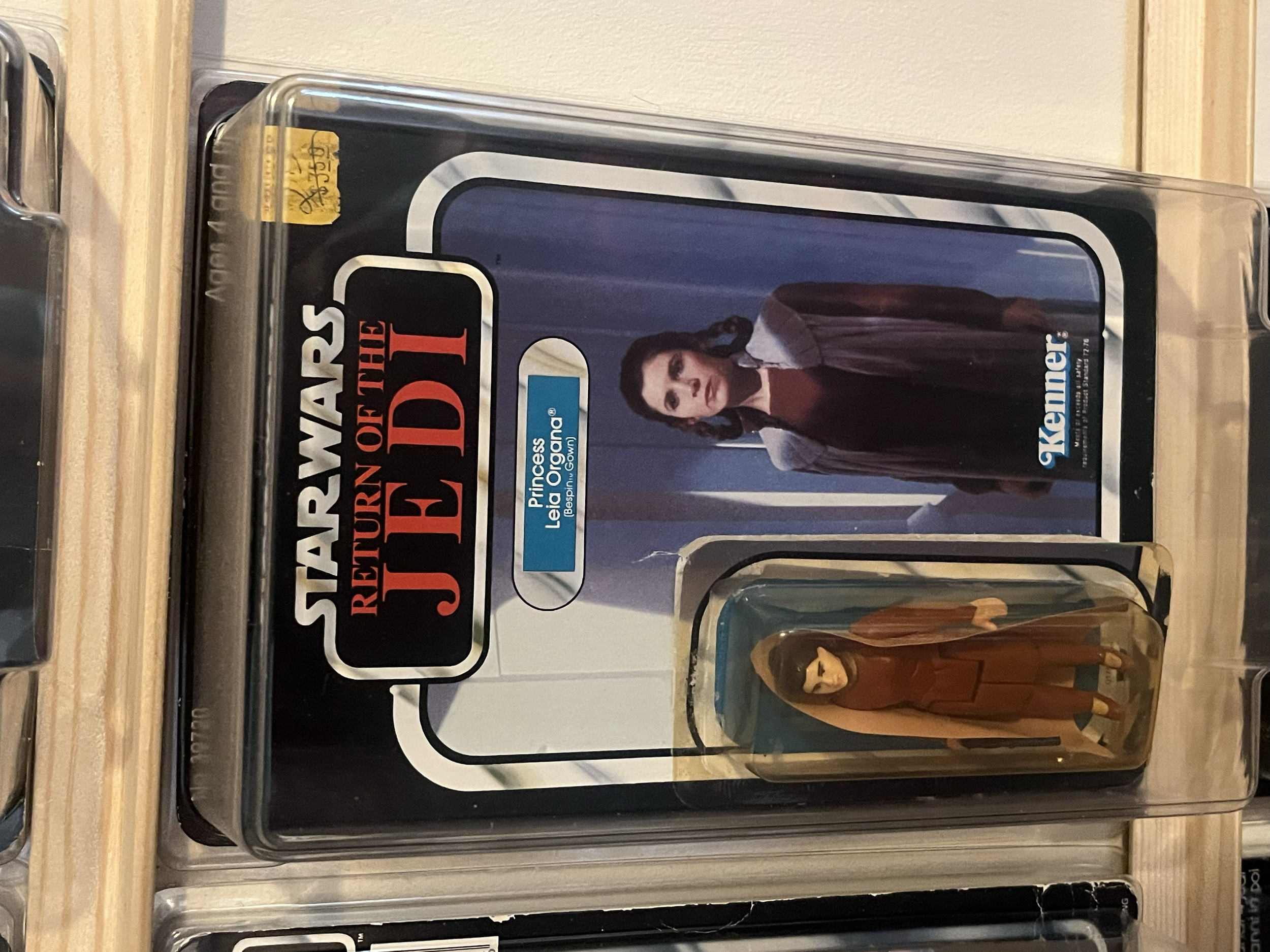 A plastic container with a 'Star Wars' themed label, featuring Princess Leia from Star Wars, on a wooden surface.