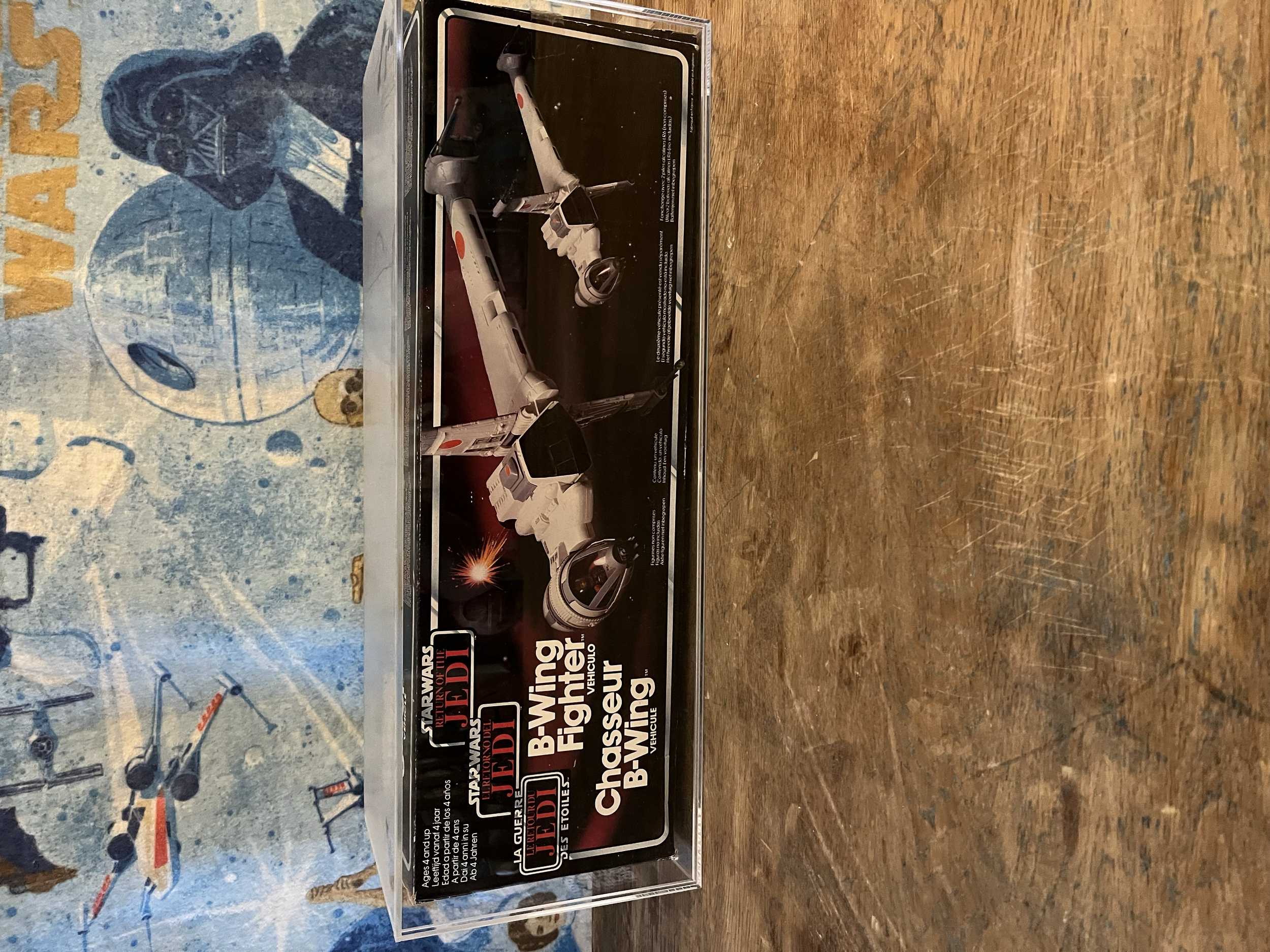 A Star Wars themed model building kit box featuring an X-Wing starfighter and R2-D2 droid.